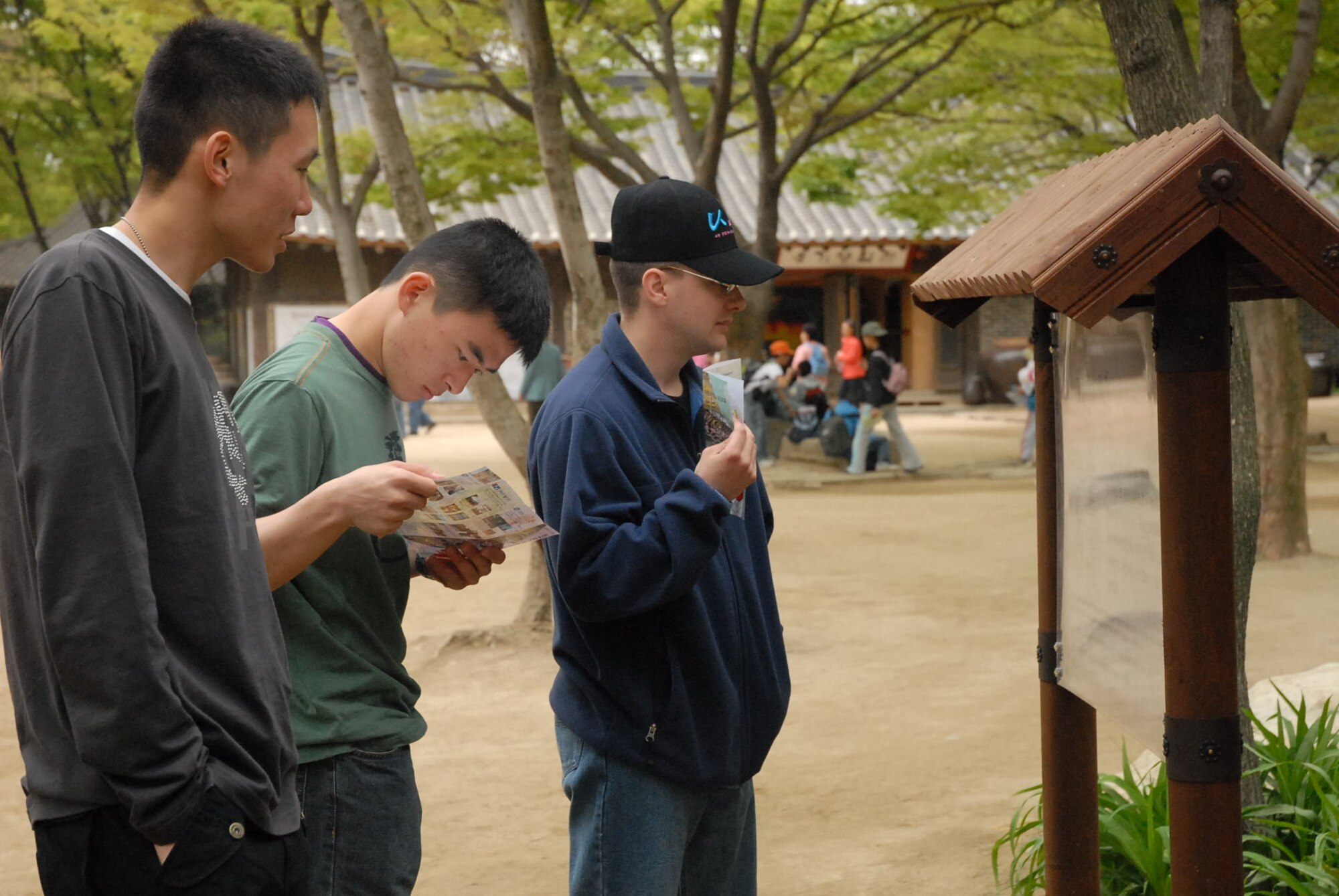 SEOUL, Republic of Korea --  Capt. Joshua M. Fishman, Sgt. Shin, Dong Il, and Sgt. Lee, Kyung Ho, read a description of a building while touring a Korean folk village during Korean Augmentees to the U.S. Army-U.S. Soldier Friendship Week. (U.S. Army photo by Pfc. Gretchen N. Goodrich)