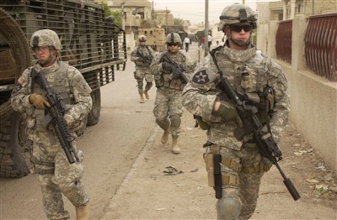 U.S. Army soldiers move down a street as they start a clearing mission in Dora, Iraq, on May 3, 2007.  Soldiers from the 2nd Platoon, Alpha Company, 2nd Battalion, 3rd Infantry Regiment, 3rd Stryker Brigade Combat Team, 2nd Infantry Division are patrolling the streets in Dora.  