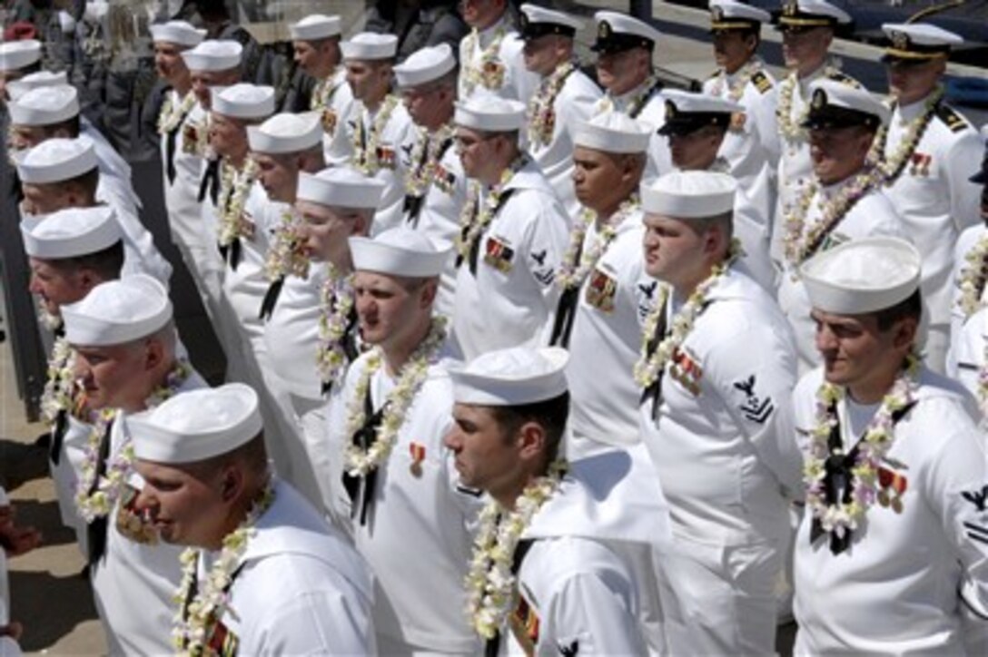 Sailors assigned to Pre-Commissioning Unit Hawaii prepare to "man the ship," and officially bring the newest Virginia-class nuclear attack submarine to life during her commissioning ceremony at Groton, Conn., May 5, 2007. 