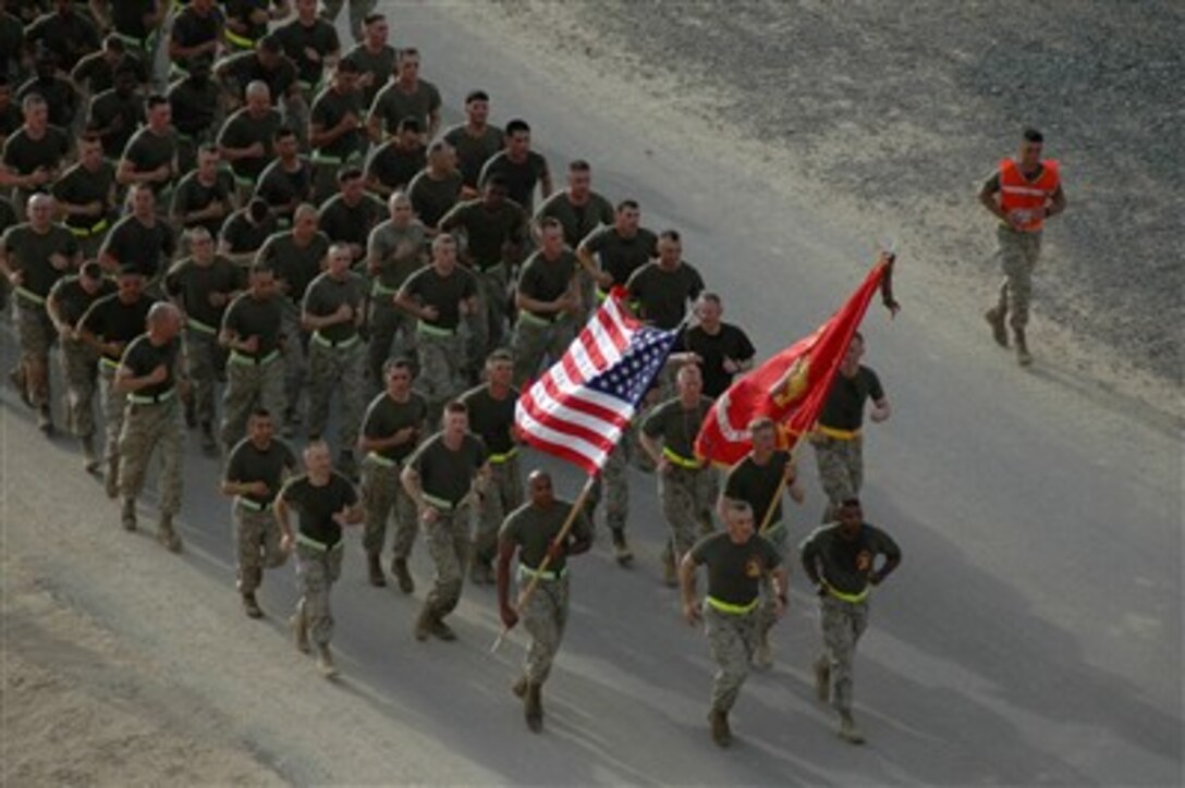 U.S. Marines and Navy sailors run in formation during a battalion run at Camp Buerhing, Kuwait, on May 4, 2007. The Marines and sailors are from Battalion Landing Team 2, 2nd Battalion, 26th Marine Expeditionary Unit.  