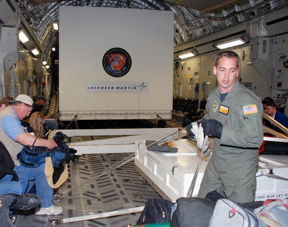 070507-O-4913D-001 BUCKLEY AIR FORCE BASE, Colo. -- Tech. Sgt. James Hader, a loadmaster with the 16th Airlift Squadron from Charleston Air Force Base, S.C. secures NASA's Phoenix Mars Lander in a C-17 here May 7. The lander, which was built at Lockheed Martin Space Systems Company's Waterton Canyon facilities in Littleton, Colo., was loaded on a C-17 for transportation to NASA's Kennedy Space Center in Florida for final test and launch preparations. The Phoenix lander is slated for liftoff aboard a Delta II launch vehicle in early August. (Photo by Chuck Diggle) 