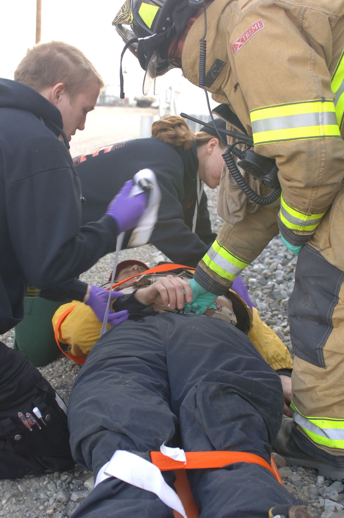 FAIRBANKS, Alaska (May 8, 2007) – Emergency Medical Technicians from the Steese, Alaska, fire department and a firefighter from the fire department here prepare a simulated mass casualty victim for movement as part of a train derailment scenario for Alaska Shield/Northern Edge 07.  AKS/NE 07 is a State of Alaska/US NORTHCOM sponsored homeland defense/defense support of civil authorities exercise; part of the national-level Ardent Sentry/Northern Edge 07. It’s an opportunity to practice responding to homeland defense and disaster events with the federal, state, local & private-sector team. U.S. Navy photo by Mass Communication Specialist 1st Class Daniel N. Woods