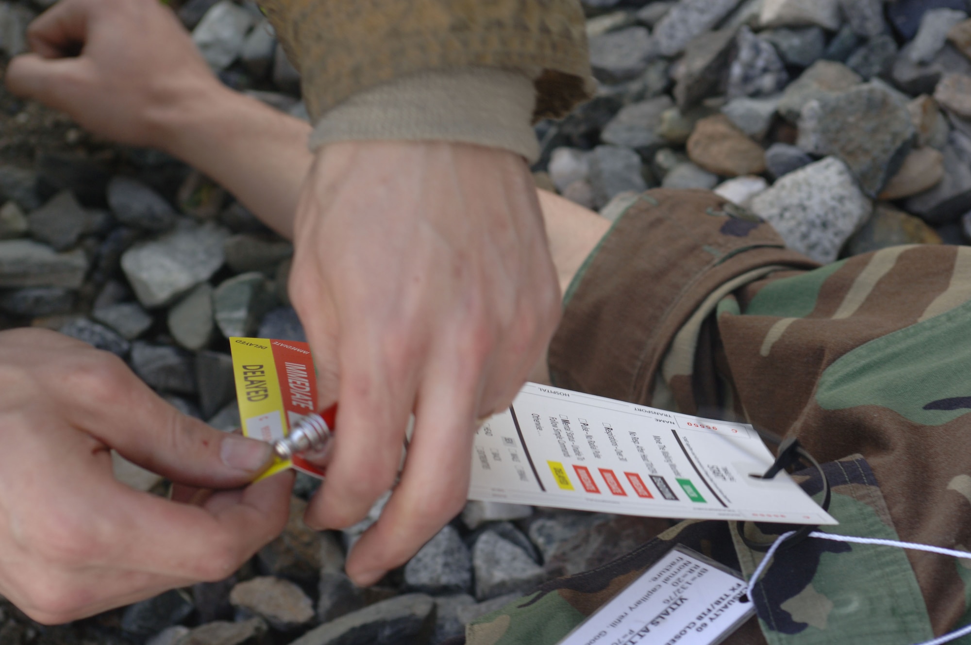 FAIRBANKS, Alaska (May 8, 2007) – A firefighter here uses a triage tag to designate the priority in which casualties should be treated as part of a train derailment mass casualty scenario for Alaska Shield/Northern Edge 07. AKS/NE 07 is a State of Alaska/U.S. Northern Command sponsored homeland defense/defense support of civil authorities exercise; part of the national-level Ardent Sentry/Northern Edge 07. It’s an opportunity to practice responding to homeland defense and disaster events with the federal, state, local & private-sector team. U.S. Navy photo by Mass Communication Specialist 1st Class Daniel N. Woods