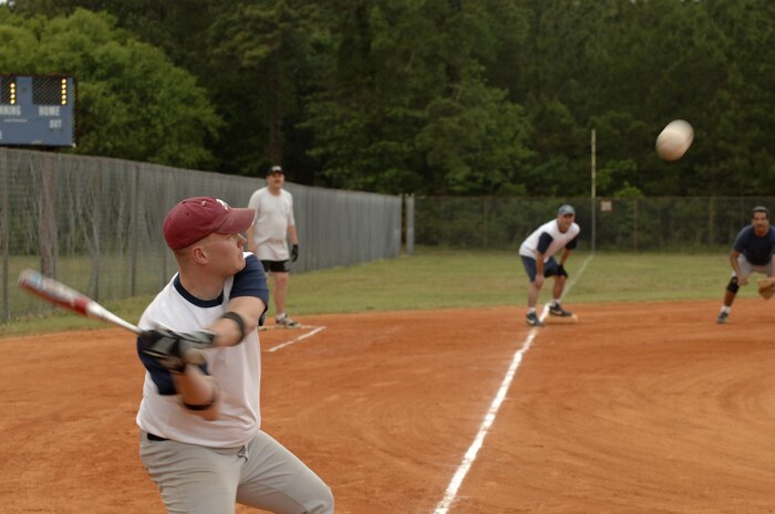 Ricky Rose, 1st Combat Camera Squadron, swings at a pitch in a game against Boeing here Tuesday night.  (U.S. Air Force photo/Staff Sgt. April Quintanilla)