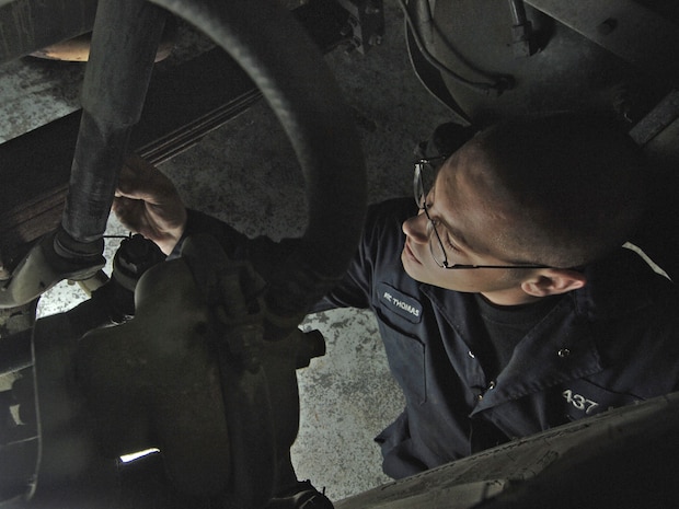 Airman 1st Class Jacob Thomas, 437th Logistics Readiness Squadron vehicle maintainer, replaces the shocks on a government vehicle.  (U.S. Air Force photo/Staff Sgt. April Quintanilla)