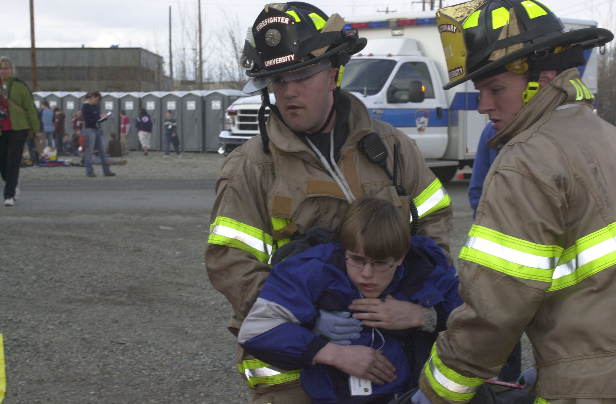 Firemen from the University of Alaska Fairbanks Fire Department carry a simulated accident victim to a triage station May 8 as part of Alaska Shield/Northern Edge 2007.  The exercises, which are scheduled to run from May 7-18, will test military and civilian authorities throughout Alaska on all aspects of emergency preparedness as they respond to a variety of scenarios ranging from natural disasters to major accidents.  On May 8, the University Fire Department, along with other local rescue workers, responded to a simulated train collision involving hazardous materials and massive casualties. (Staff Sgt. J.G. Buzanowski)