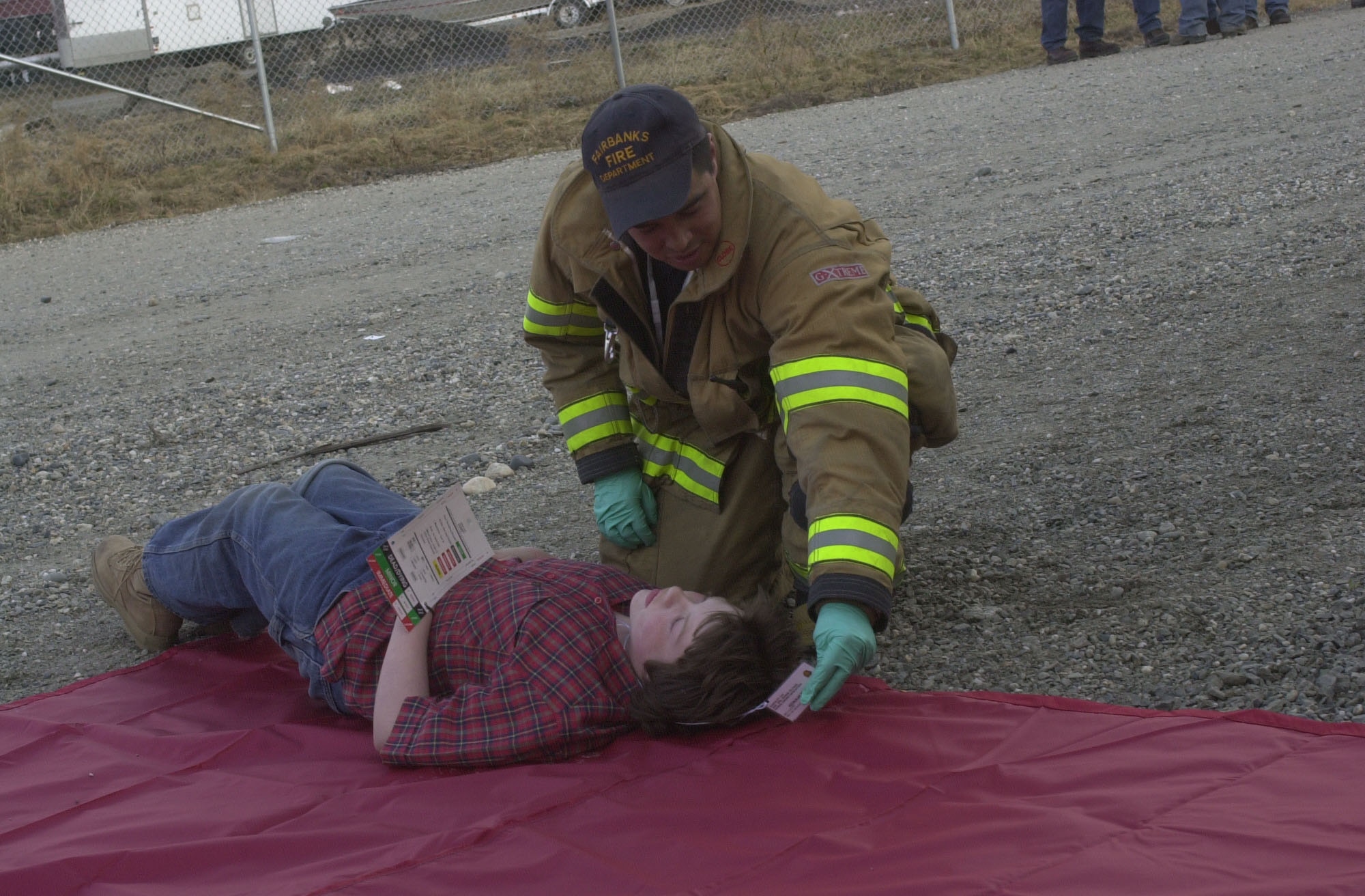 Mike Gho of the Fairbanks Fire Department checks the triage status of a simulated accident victim May 8 as part of Alaska Shield/Northern Edge 2007.  The exercises, which are scheduled to run from May 7-18, will test military and civilian authorities throughout Alaska on all aspects of emergency preparedness as they respond to a variety of scenarios ranging from natural disasters to major accidents.  On May 8, the Fairbanks Fire Department, along with other local rescue workers, responded to a simulated train collision involving hazardous materials and massive casualties. (Staff Sgt. J.G. Buzanowski)