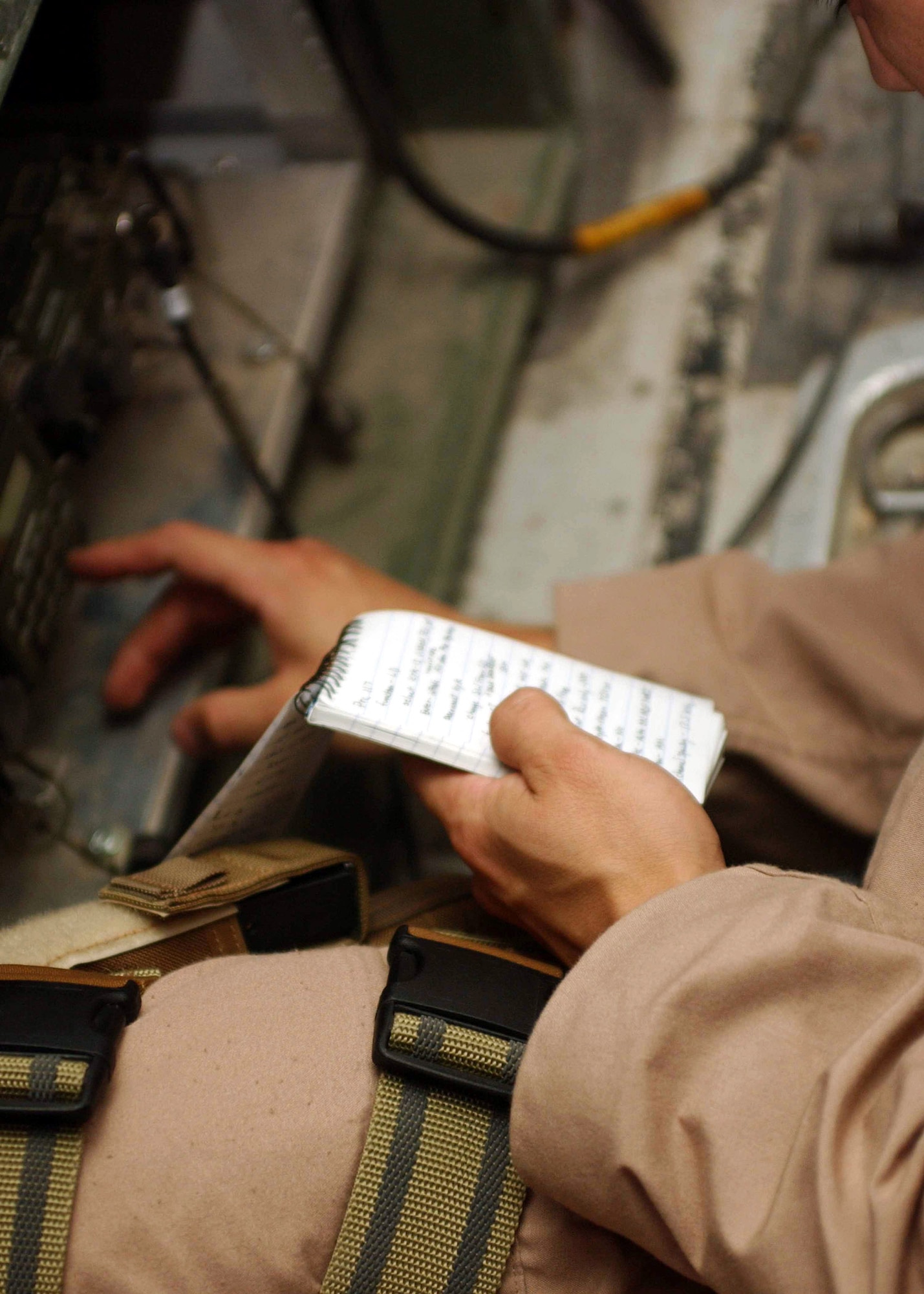 Senior Airman Raymond Felix checks radio frequencies before taking off on a Joint Airborne Battle Staff mission over Iraq.  While they fly, joint service battle staff members monitor several radio channels at a time, listening in on coalition convoys on the ground and relaying radio calls when necessary, ranging from routine radio checks to medical evacuation requests.  Airman Felix is a communications technician with the battle staff.  (U.S. Army photo/Army Sgt. Alexandra Hemmerly-Brown)