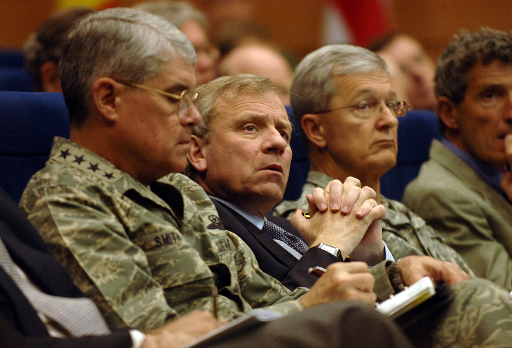 NATO Secretary General Jaap de Hoop Scheffer, flanked by Gen. Lance L. Smith (left)   and Army Gen. John Craddock tune into a lecture May 4 during the week-long NATO Response Force Exercise Allied Reach '07 at Allied Air Component Command Headquarters at Ramstein Air Base, Germany. The NATO commanders, along with representatives from 26 NATO nations attended the exercise that examined the command and control, logistics and training of the NATO Response Force at the strategic and operational levels. General Smith is the commander, U.S. Joint Forces Command/NATO Supreme Allied Commander Transformation. General Craddock is the Supreme Allied Commander, Europe. (U.S. Air Force photo/Master Sgt. Scott Wagers) 

