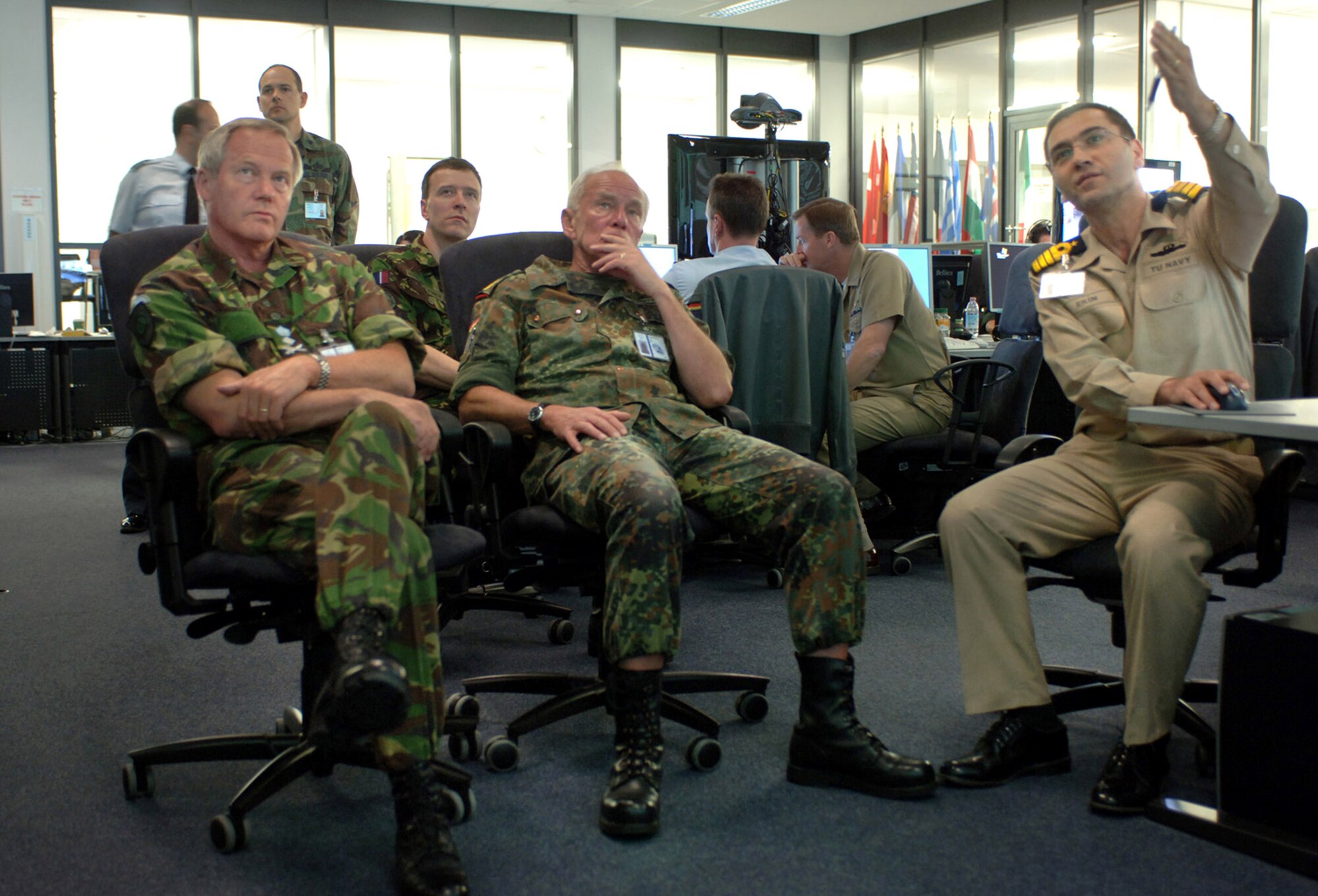 British Gen. Sir John Reith and German Gen. Ranier Shuwirth receive an operations brief May 3 from Turkish Naval Capt. Cengiz Ekin on an interactive software tool used to assess battlefield operations at Allied Air Component Command Headquarters at Ramstein Air Base, Germany. The NATO commanders and representatives from 26 NATO nations were attending the week-long NATO Response Force Exercise Allied Reach '07. General Reith is the deputy Supreme Allied Commander Europe, and General Shuwirth is the SHAPE chief of staff. (U.S. Air Force photo/Master Sgt. Scott Wagers)
