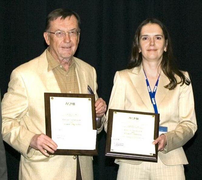 HONOLULU, Hawaii -- Dr. Bob Sierakowski, Air Force Research Laboratory Munitions Directorate chief scientist, and co-author Olesya I. Zhupanska, University of Florida, recently received an award for co-authoring a paper selected as the best of more than 1,900 entries. The technical paper entitled, "A Study of Impacted Electromechanically Loaded Composite Plates," was named the 2007 American Society of Mechanical Engineers Boeing Best Paper by the ASME Aerospace Division's Structure and Materials Committee. (Photo courtesy by Paramount Photography, Honolulu, Hawaii)