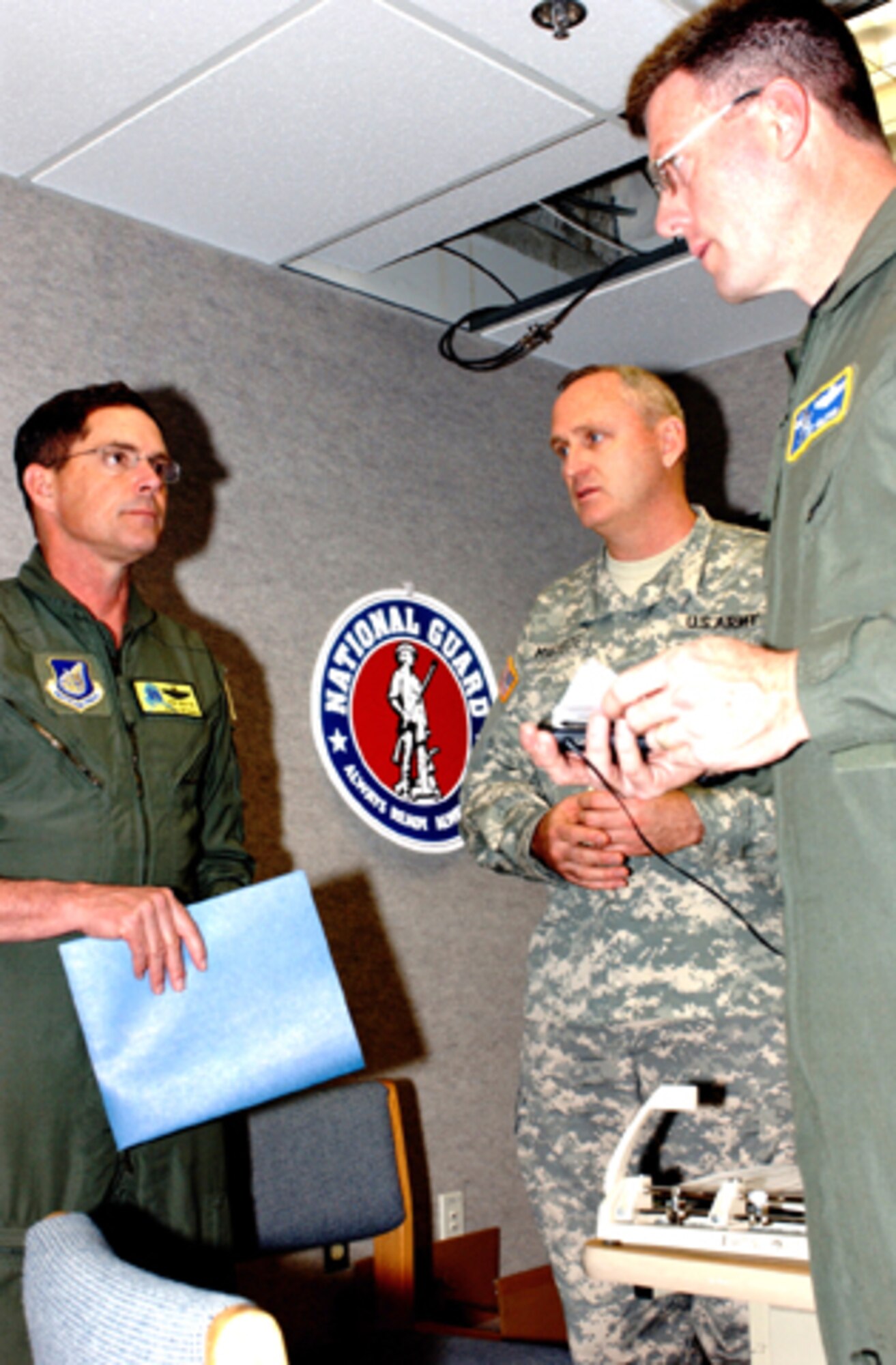 Col. John Griffin of the 168th Air Refueling Wing of the Alaska Air National Guard and Lt. Col. James Midyette of the 60th Troop Command Unit of the North Carolina National Guard and Lt. Col. Ted Gload of the National Guard Bureau at the Pentagon discuss aspects of Alaska Shield/Northern Edge. Photo by Pvt. 1st Class John Wood, 29th Infantry Division, Virginia National Guard