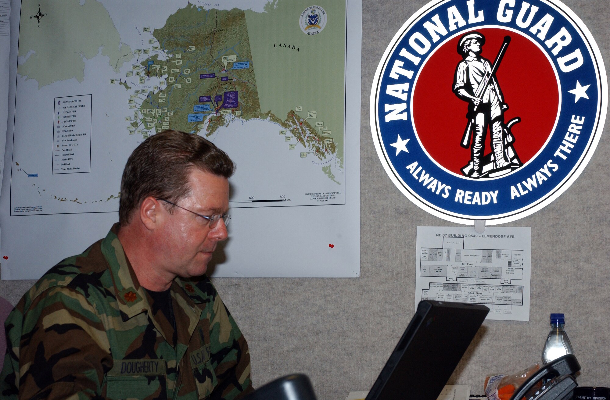 Maj. Bruce Dougherty of the 459th Aerial Medical Evacuation Squadron at Andrews Air Force Base, Virginia, concentrates on his important work at the medical liaison desk in the Joint Operations Center at the Joint Forces Headquarters-Alaska for exercise Alaska Shield/Northern Edge. Photo by Pvt. 1st Class John Wood, 29th Infantry Division, Virginia National Guard 