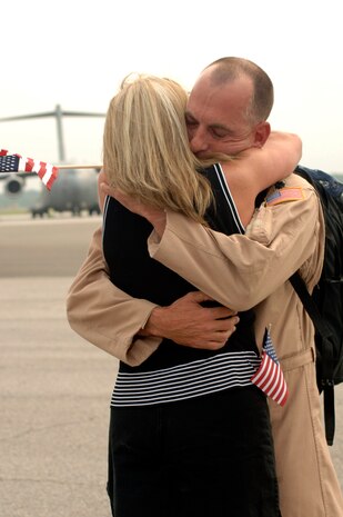 Lt. Col. Joseph Heirigs, 15th Airlift Squadron, embraces of his wife, Kathy, after being deployed for four months in Southwest Asia, May 5.  (U.S. Air Force photo/Staff Sgt April Quintanilla)