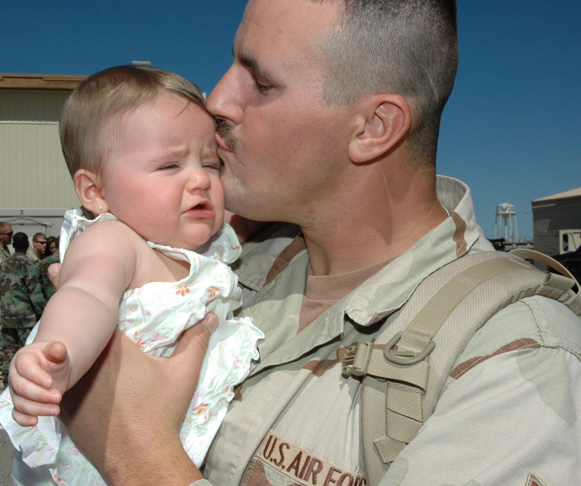 MOUNTAIN HOME AIR FORCE BASE, Idaho -- Staff Sgt. Brent Rice reunites with his daughter, Kayden, after the sergeant and other members of the 366th Civil Engineer Squadron returned here May 8 after a nearly seven-month deployment to the Middle East. The base welcomed home 35 members from the squadron, who served at forward operating locations in Iraq and Afghanistan to build new work centers and living quarters and expand these bases to accommodate additional forces arriving in the region as part of the U.S. military’s ongoing troop surge. Air Force photo by Master Sgt. Brian S. Orban