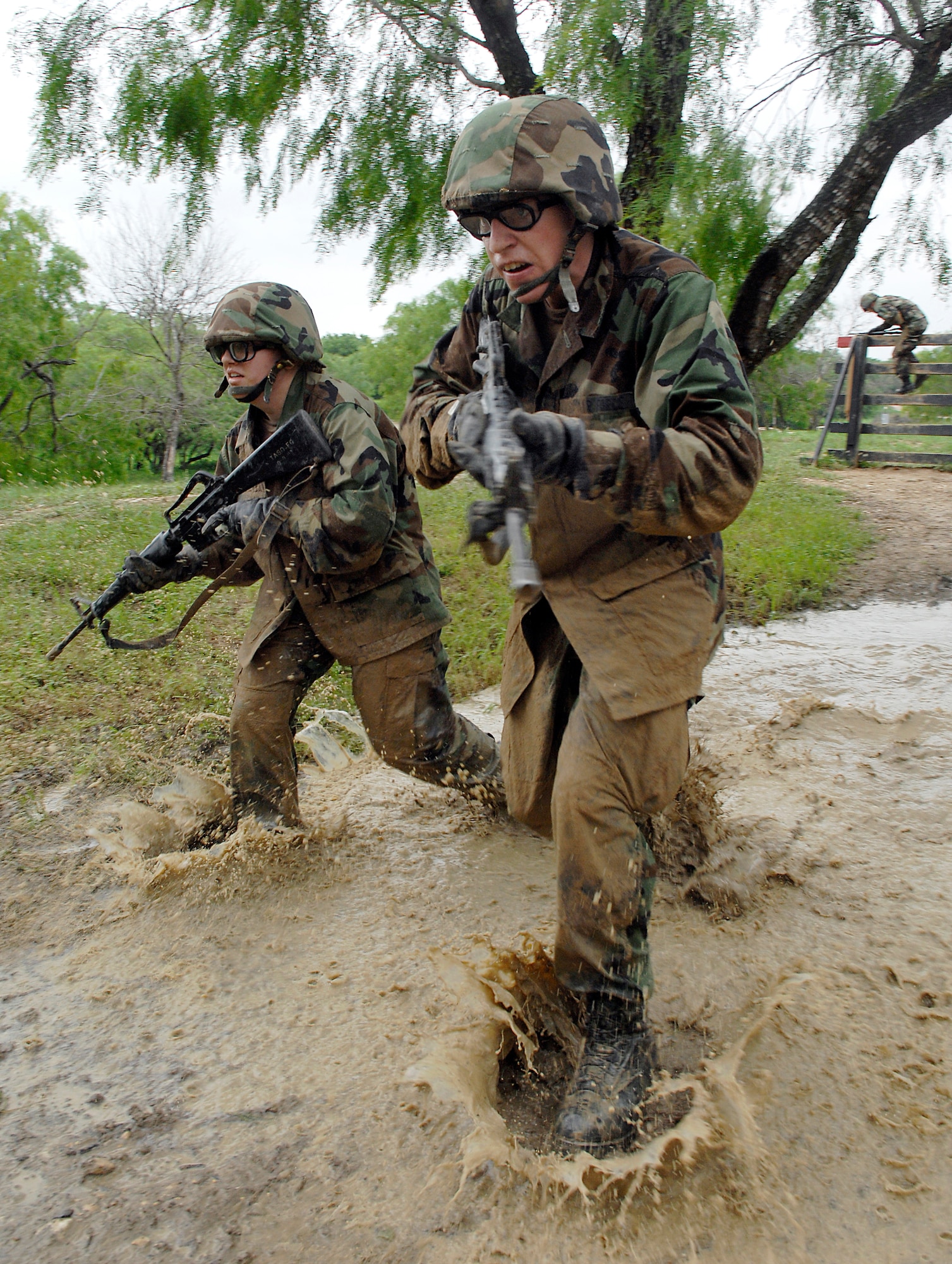 Basic trainees navigate through a muddy part  of the tactical assault course at the field training site on Lackland Air Force Base, Texas on May 2. This half-mile course, consisting of numerous obstacles, tests the trainees' newly-acquired defensive tactics skills and enforces the need to properly communicate with their wingmen. (U.S. Air Force photo/Tech. Sgt. Larry A. Simmons)