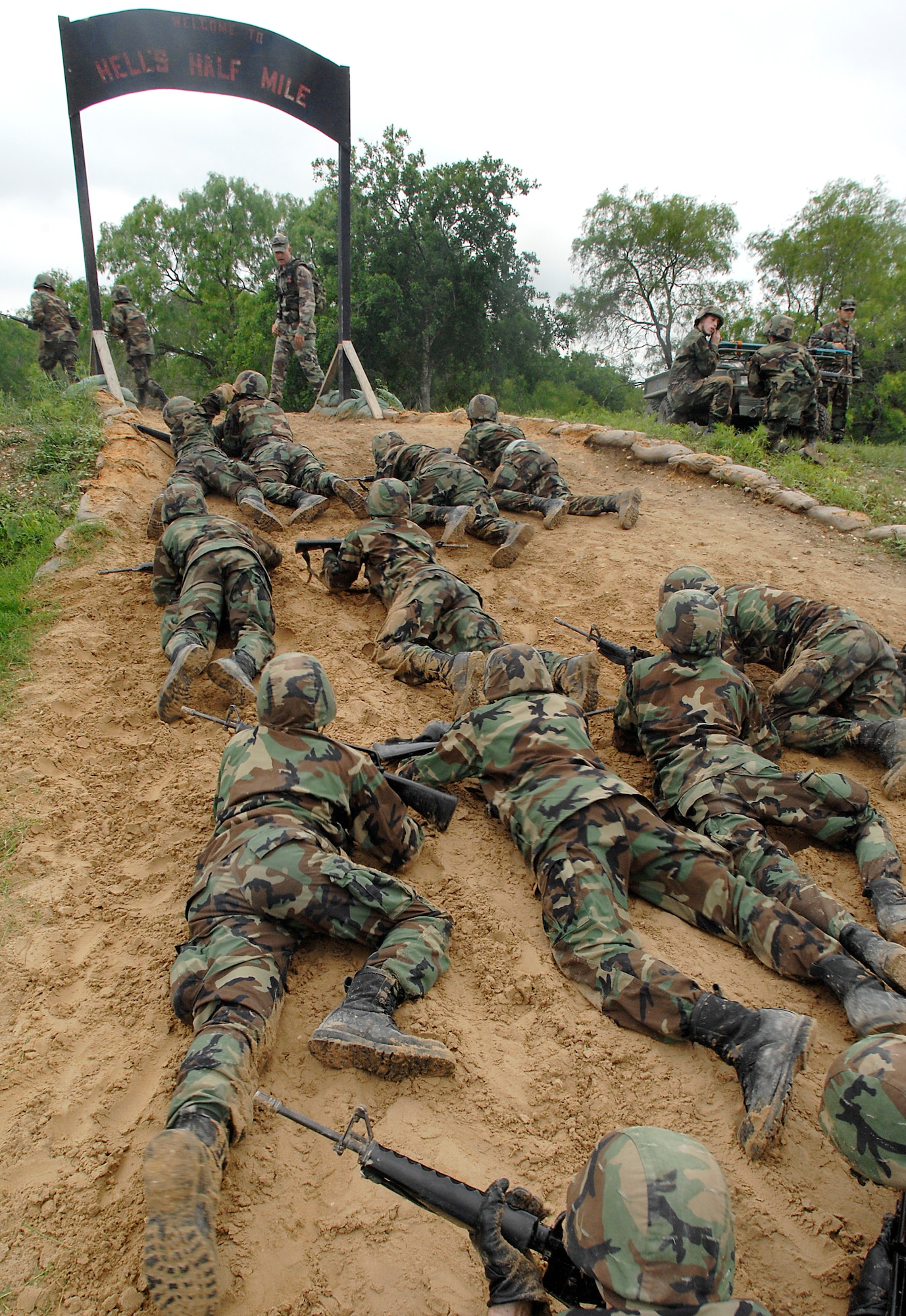 Basic trainees navigate through the tactical assault course at the field training site on Lackland Air Force Base, Texas on May 2. This half-mile course, consisting of numerous obstacles, tests the trainees' newly-acquired defensive tactics skills and enforces the need to properly communicate with their wingmen. (U.S. Air Force photo/Tech. Sgt. Larry A. Simmons)