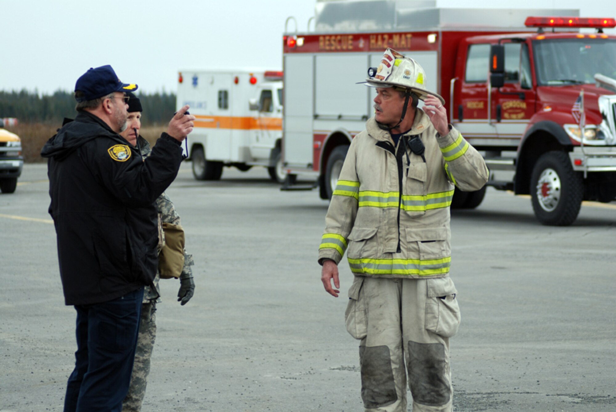 Ron Bishop, chief of the Cordova police department, and Lt. Col. Brian Shields, commander of the 101st Civil Support Team (Weapons of Mass Destruction) from Boise, Idaho, call in Mike Hicks, chief of the Cordova Fire Department to check suspicious chemicals found on a private jet. All three are participating in Alaska Shield/Northern Edge, a joint training exercise designed to test military and civilian responses and coordination capabilities should multiple terrorist attacks occur throughout the state of Alaska. Photo by Spec. Frank O’Brien, 29th Infantry Division, Virginia National Guard