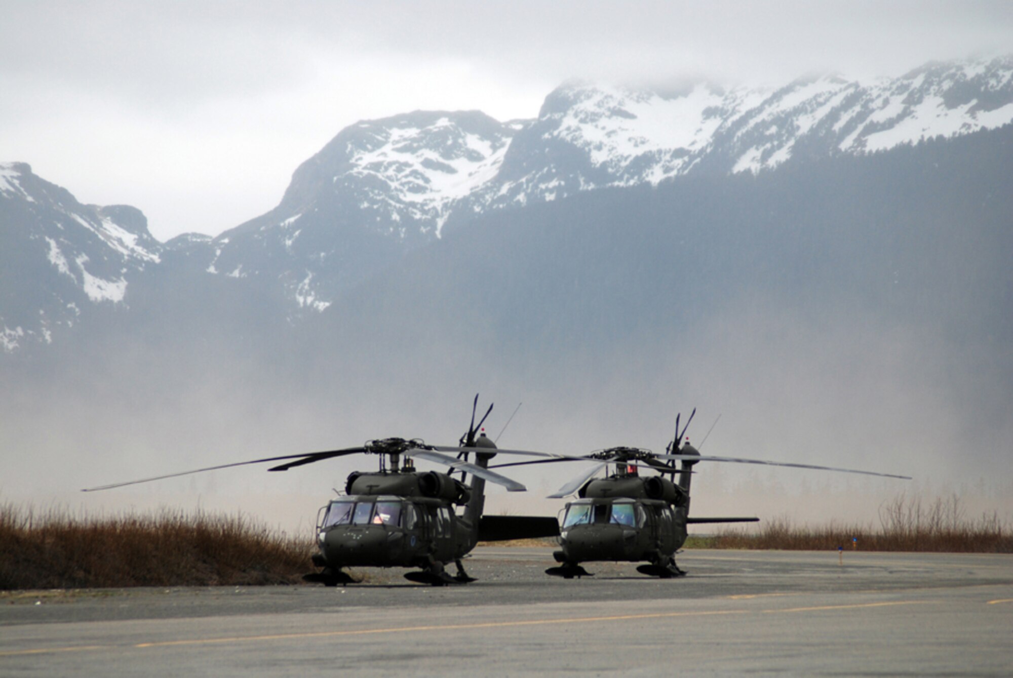 Two UH-60 Black Hawk helicopters from the Alaska Army National Guard land at the Cordova, Alaska, Airport to retrieve Soldiers and Airmen participating in the kick-off exercise of Alaska Shield/Northern Edge. Alaska Shield/Northern Edge is a joint training exercise designed to test military and civilian responses and coordination capabilities should multiple terrorist incidents occur throughout the state of Alaska. Photo by Spec. Frank O’Brien, 29th Infantry Division, Virginia National Guard
