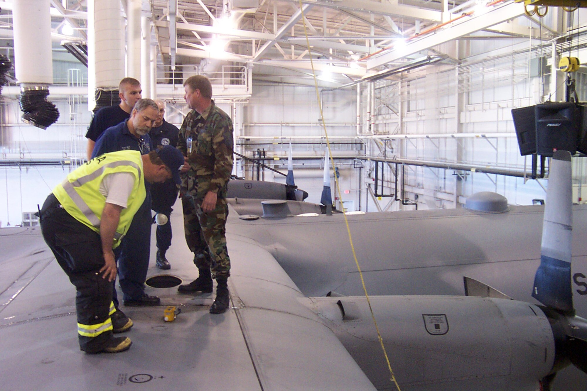 YOUNGSTOWN AIR RESERVE STATION, OH—Air Force Reserve Master Sgt. Kevin Pratt (Right), a Fuels system supervisor with the 910th Maintenance Squadron, explains to local Vienna Rescuers how tank readings are monitored following an emergency response and rescue training exercise.  The May 6 exercise scenario involved a fuels technician becoming incapacitated inside a C-130 wing fuel tank while performing maintenance duties. Mike Hagood (Front), Assistant Fire Chief for the Vienna Fire Department studies the Photoionization detector (PID).  The detector uses an ultraviolet lamp to ionize vapor molecules measuring JP-8  (fuel used for C-130s) in parts per million and an estimate of JP-8 Lower Explosive Limit.  This exercise is an annual requirement to train all tasked personnel in their response capabilities. U.S. Air Force Photo/Capt. Brent J. Davis