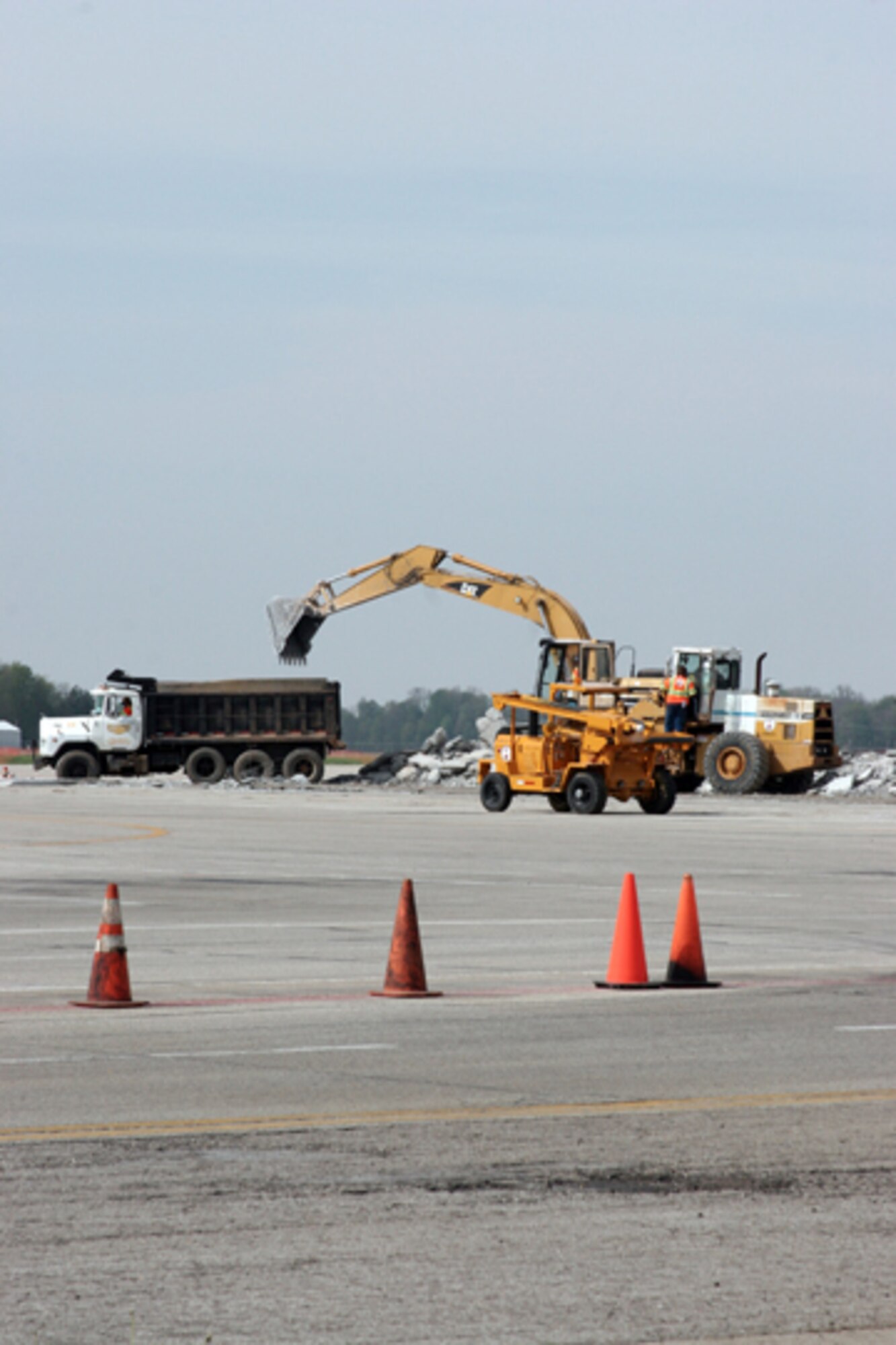 GRISSOM AIR RESERVE BASE, Ind. -- Contract crews remove debris during the construction project on the mass parking ramp here. The upgrade will enhance KC-135R operations on the base and is one of the many renovation projects scheduled for 2007 at Grissom. (U.S. Air Force photo/Senior Airman Omar Delacruz)
