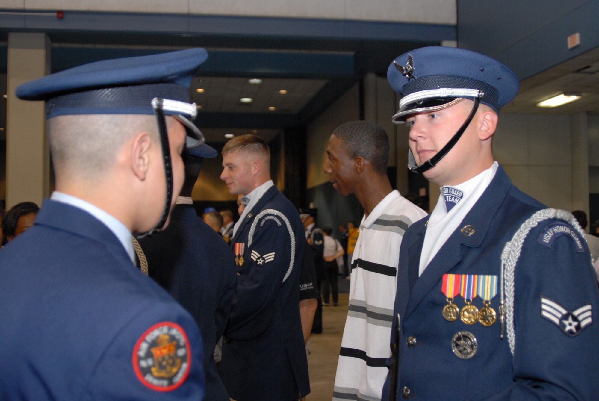 DAYTONA, Fla. - Senior Airman David Leininger, Air Force Honor Guard Drill Team member, talks with a JROTC cadet after the team's performance at the National High School Drill Team Championships May 6.  The team's performance was the last of their latest tour to Florida, in which they also performed for the Ft. Lauderdale Air and Sea Show.