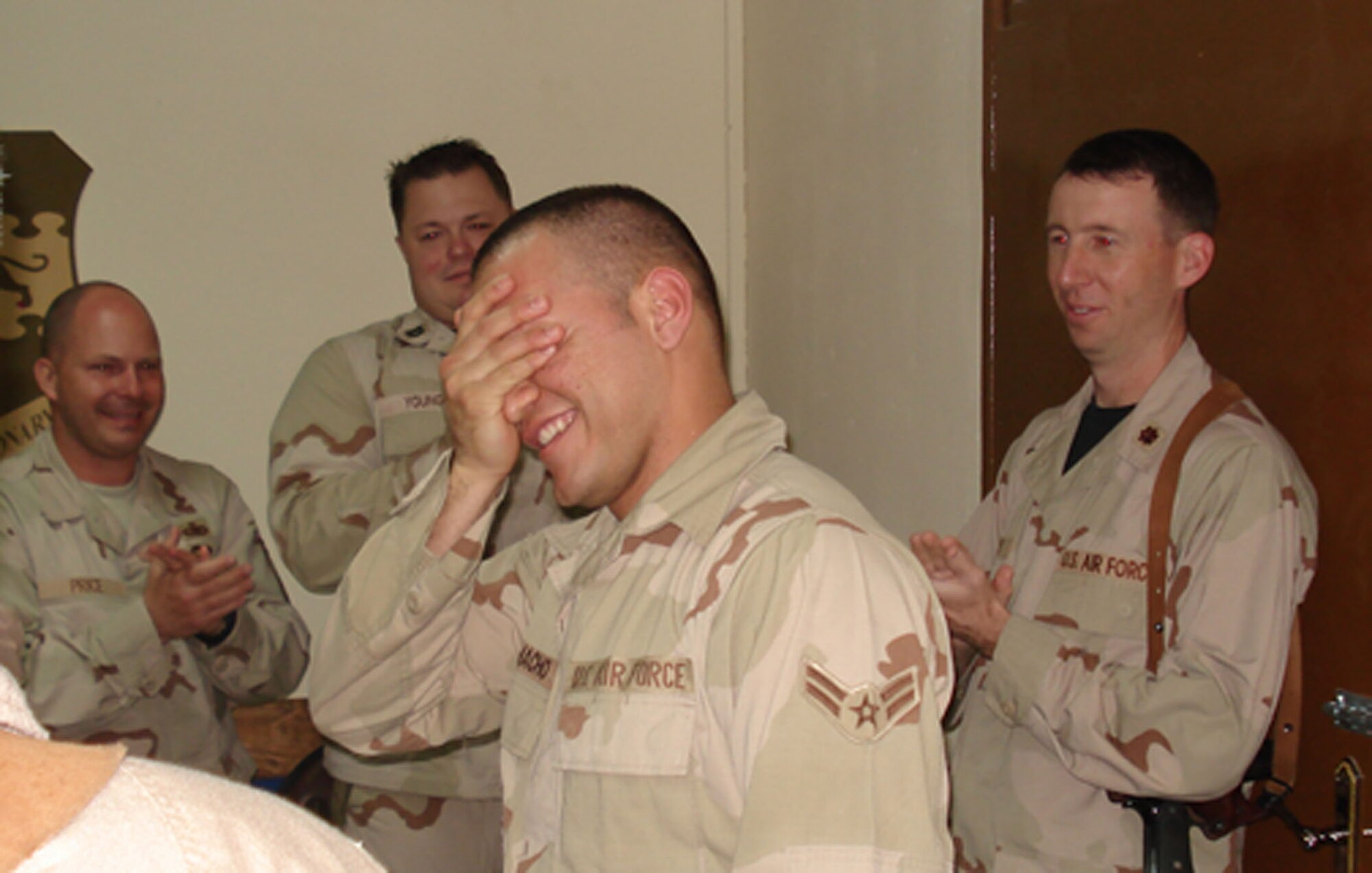 Airman 1st Class Edward Camacho, a supply technician deployed from Aviano AB, Italy to the 332nd Expeditionary Logistics Squadron at Balad, reacts with disbelief moments after Brig. Gen. Robin Rand, 332nd Air Expeditionary Wing commander, notified him of his selection to the U.S. Air Force Academy Preparatory School. Airman Camacho, who recently emigrated from Venezuela to America in hopes of becoming an officer, pilot and ultimately an astronaut, moves one step closer to those goals following the surprise announcement at the wing's daily update brief.                                