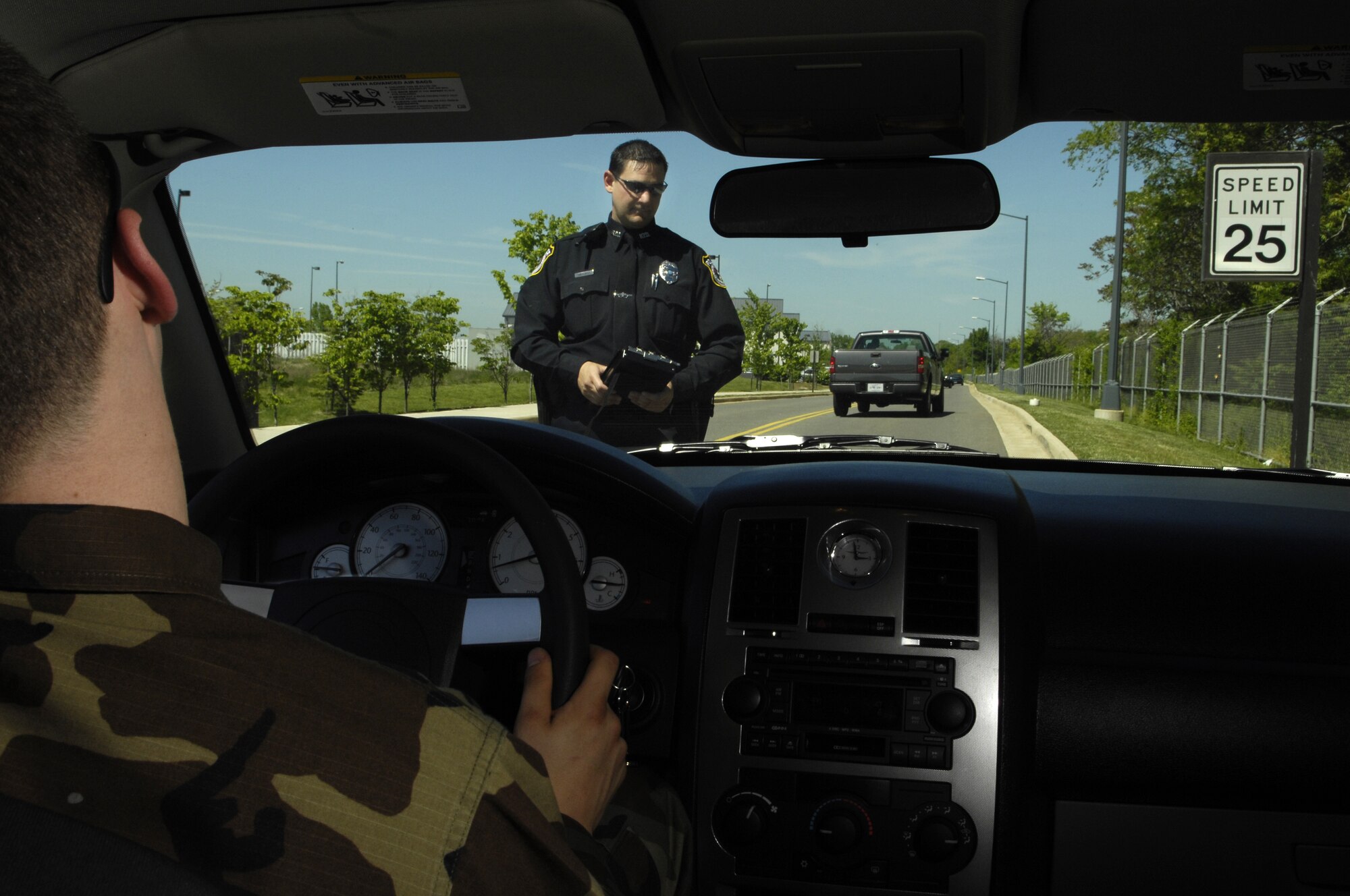 Department of Defense Police Officer Richard Twitchell checks the liscene plate number before issuing a  speeding ticket on Bolling May 8. The 101 critical days of summer are aproaching and speeding is one of the leading causes of accidents every year. (U.S. Air Force Photo by Senior Airman Dan DeCook)