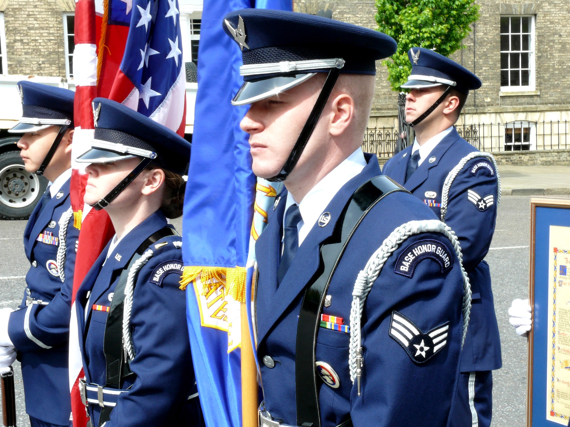 Second Lt. Kelly Collier (center) holds the American flag, as Senior Airman Daniel Anderson (right) holds the Air Force flag during the America 400 parade May 8 in Bury St. Edmunds, United Kingdom. The celebration is in remembrance of the 400th Anniversary of Jamestown, Va., the first permanent English settlement in America.(U.S. Air Force photo/Tech. Sgt. Scott Wakefield) 
