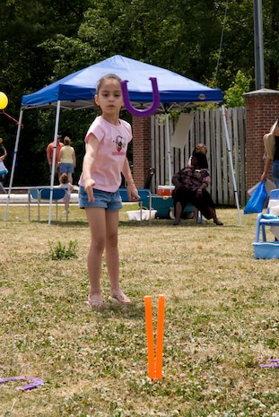 Dominique Worrell, 6, daughter of Tech. Sgt. Sean Worrell, plays horeshoes at the Month of the Military Child Festival Saturday. (U.S. Air Force photo/Airman Melissa Harper)