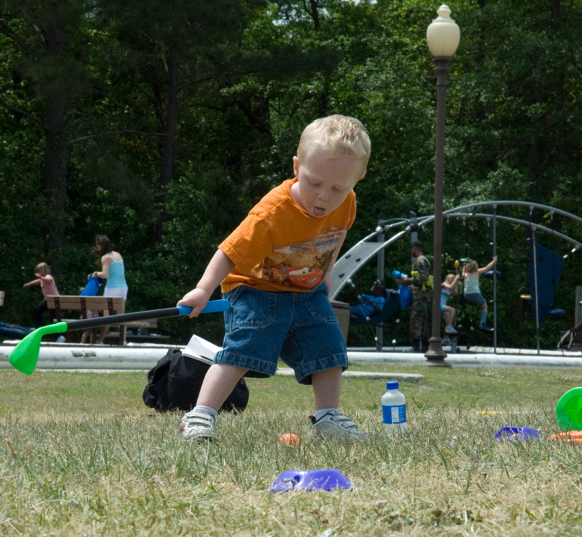 Wyatt Long, 2, son of Staff Sgt. Charlie Long, goes golfing at the Month of the Military Child Festival at the Youth Programs Center Saturday. (U.S. Air Force photo/Airman Melissa Harper)