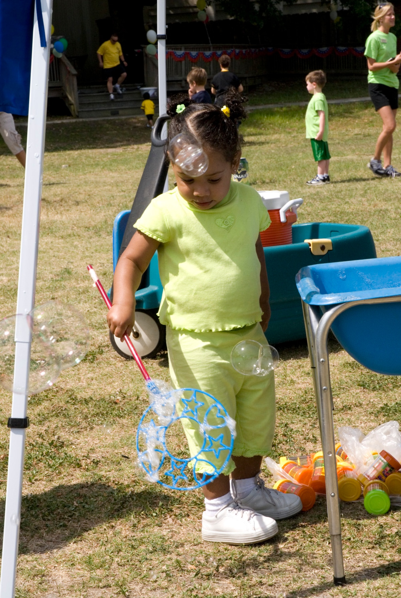 Cyrene Brenna, 21 months, grandaughter of Tech. Sgt. Kevin Swiecicki, plays with bubbles at the Month of the Military Child Festival Saturday. (U.S. Air Force photo/Airman Melissa Harper) 