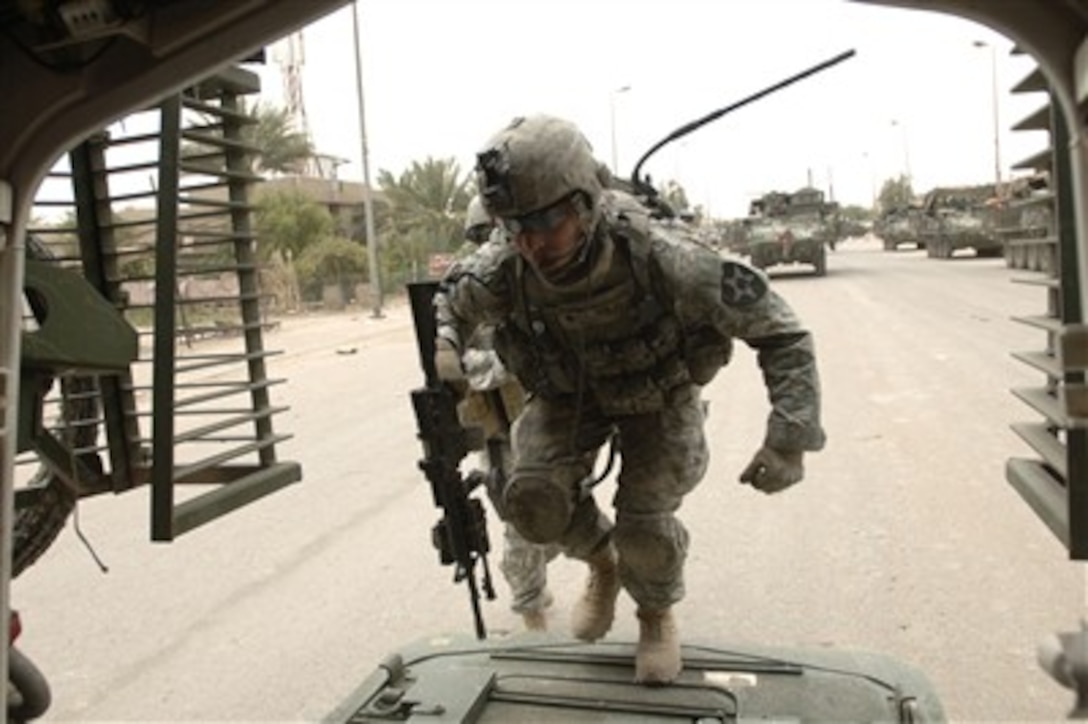 U.S. Army Spc. Solis enters a Stryker assault vehicle after completing a clearing mission in Baghdad, Iraq, on May 6, 2007.  Solis is assigned to the 2nd Battalion, 3rd Infantry Brigade Combat Team.  
