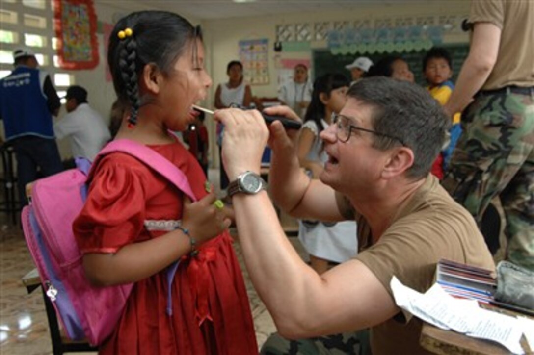 U.S. Air Force Col. Victor Onufrey examines a young girl as part of a medical readiness exercise during New Horizons-Panama 2007 in Chiriqui Grande, Panama, on April 25, 2007.  The joint humanitarian and training exercise with the Panamanian military is providing three new schools, a medical clinic, and free health and veterinary care to the local populace.  Onufrey is the state air surgeon from the Headquarters, Pennsylvania Air National Guard.  