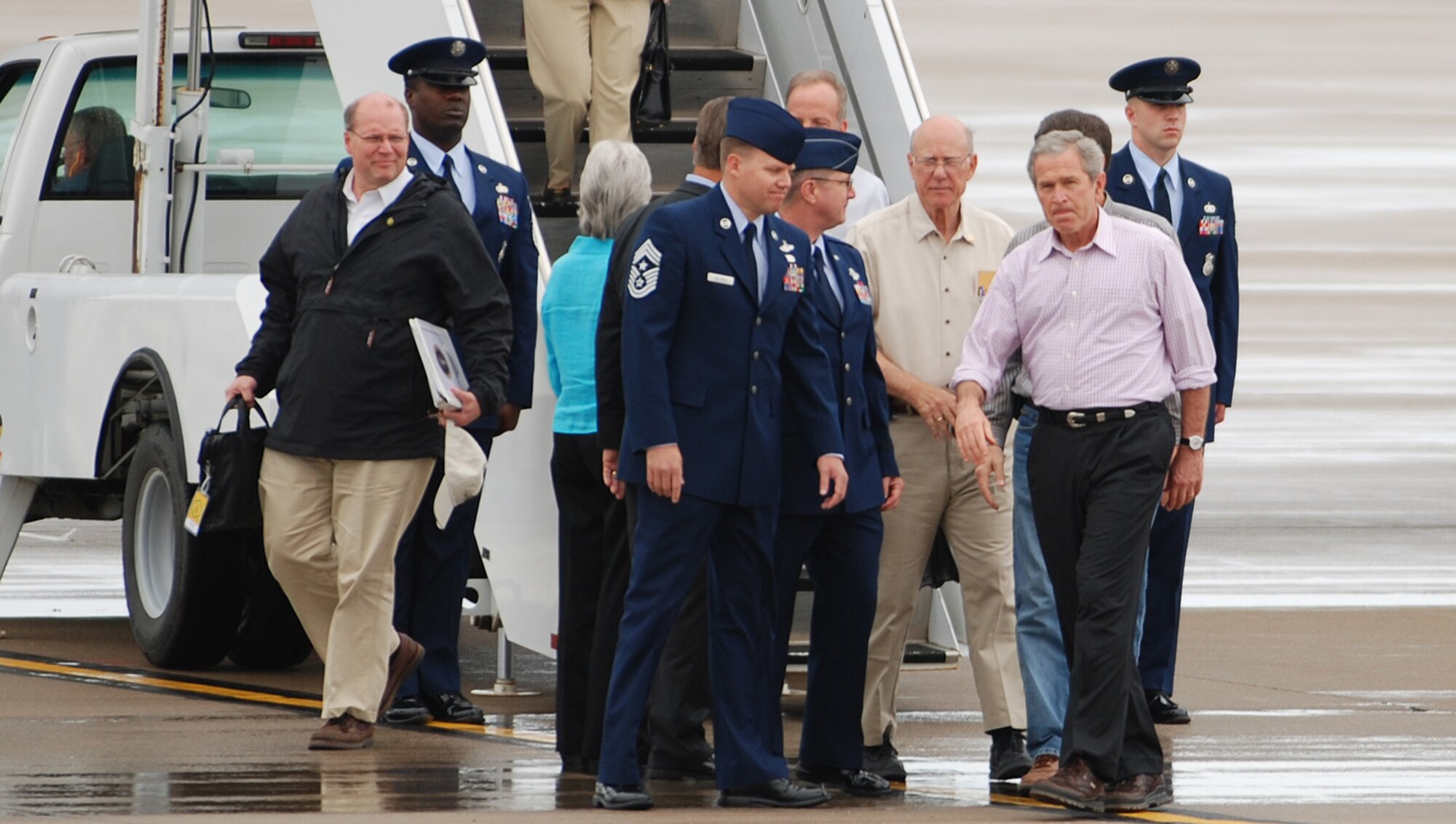 President George W. Bush walks across the flightline after receiving a greeting from Col. Donald Halpin, 22nd Air Refueling Wing commander, and Chief Master Sgt. Todd Salzman, 22nd ARW command chief, after departing Air Force One May 9 at McConnell Air Force Base, Kan. The president transited through McConnell on his way to meet victims of the Greensburg, Kan., tornado disaster. Greensburg is approximately 120 miles west of the base and was struck by a tornado May 4. (Photo by Airman 1st Class Jessica Lockoski)