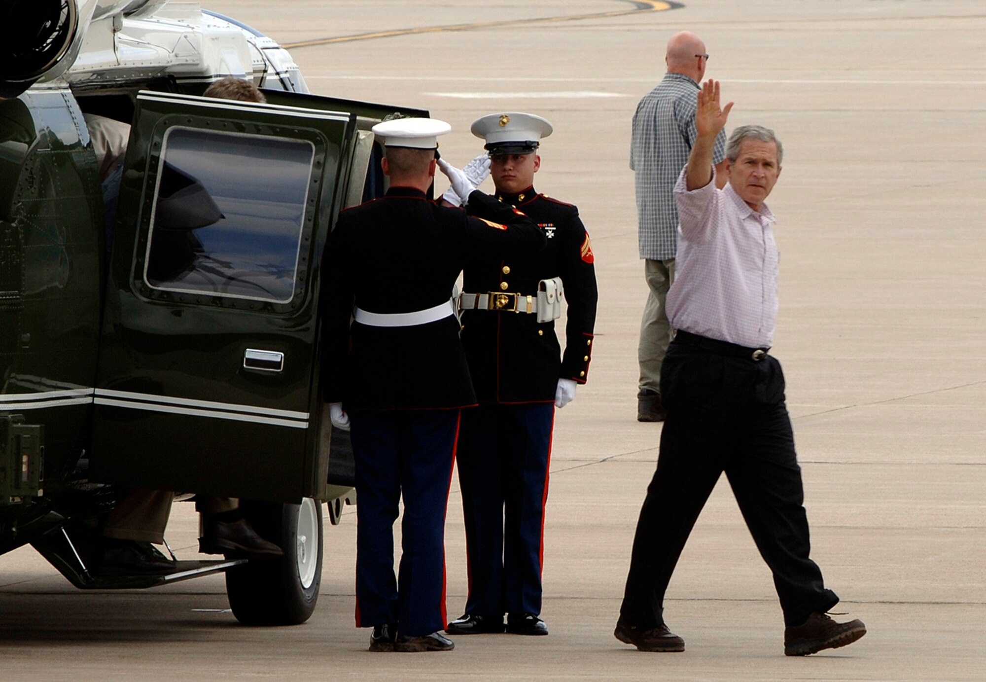 President George W. Bush waves to reporters after returning to McConnell Air Force Base from a visit to Greensburg, Kan., on Marine One May 9.  The president transited through McConnell to meet with victims of the tornado disaster, which struck Greensburg, approximately 120 miles west of the base, May 4. (Photo by Senior Airman Jamie Train)