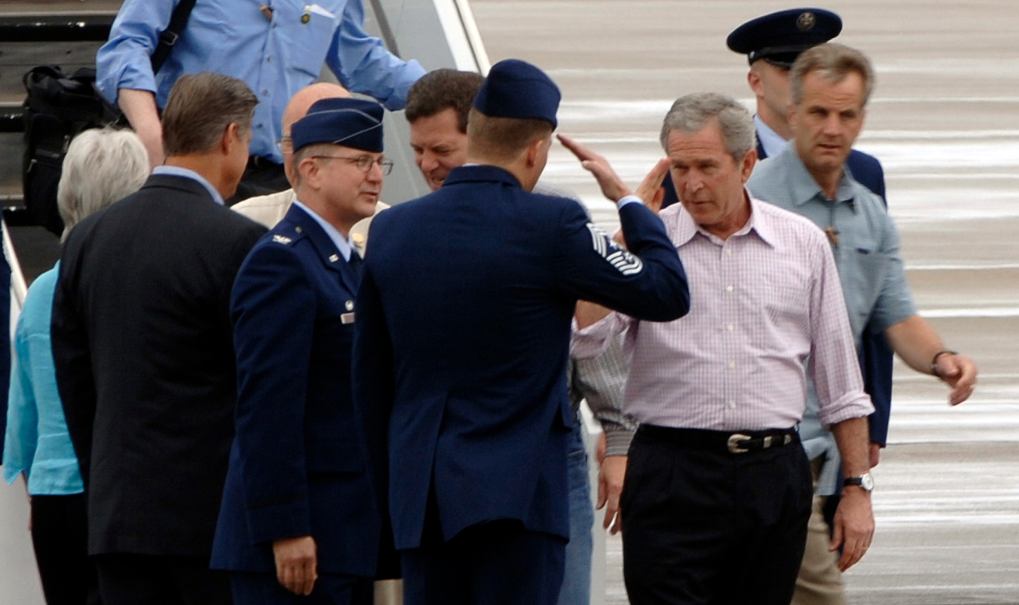 President George W. Bush salutes Chief Master Sgt. Todd Salzman, 22nd Air Refueling Wing command chief after arriving on Air Force One May 9 at McConnell Air Force Base, Kan., as Col. Donald Halpin, 22 ARW commander looks on.  The president transited through McConnell on his way to meet with victims of the Greensburg, Kan., tornado disaster. (Photo by Senior Airman Jamie Train)