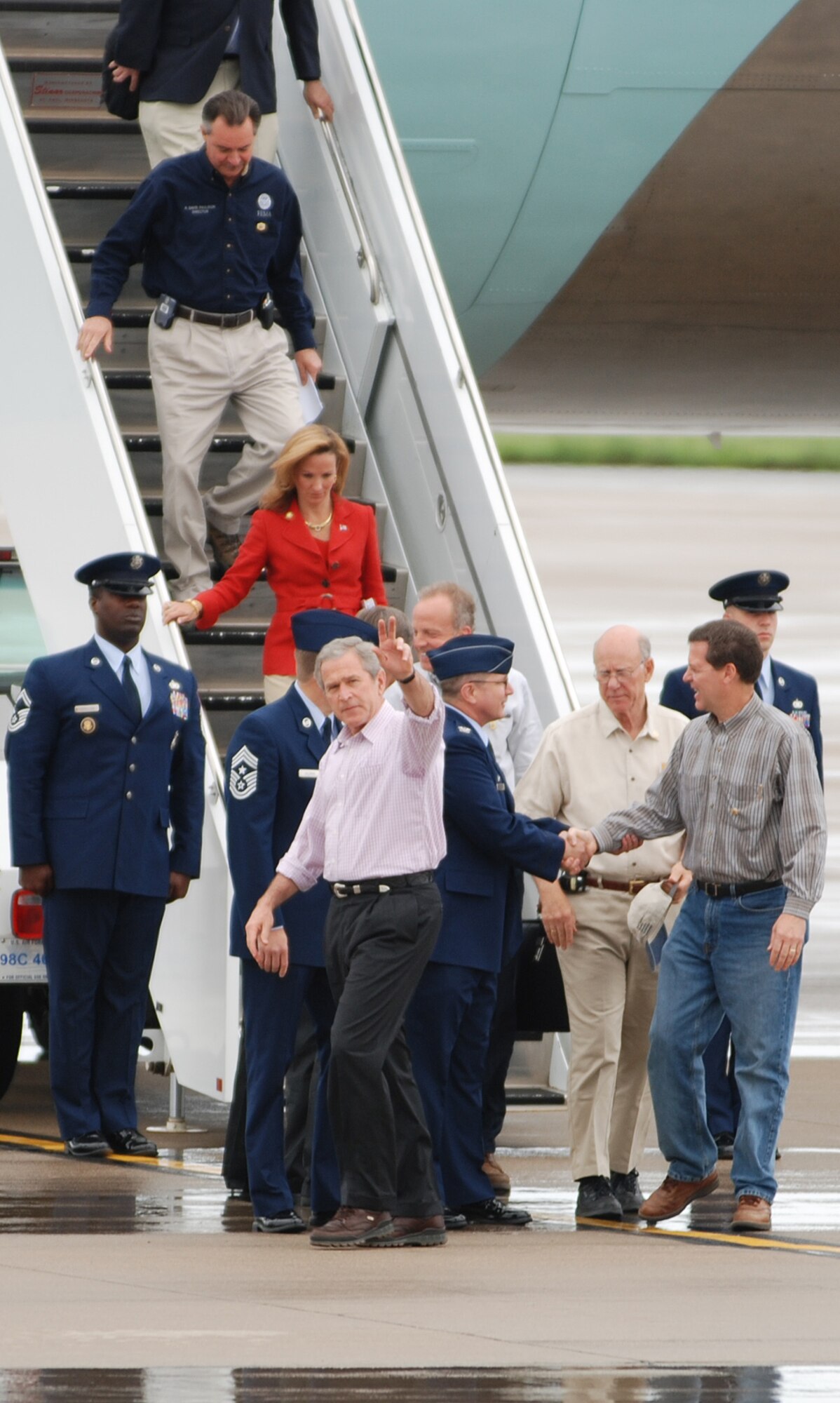 President George W. Bush waves to reporters after departing Air Force One May 9 at McConnell Air Force Base, Kan. The president transited through McConnell on his way to meet victims of the Greensburg, Kan., tornado disaster. Greensburg is approximately 120 miles west of McConnell and was struck by a tornado May 4. (Photo by Airman 1st Class Jessica Lockoski) 