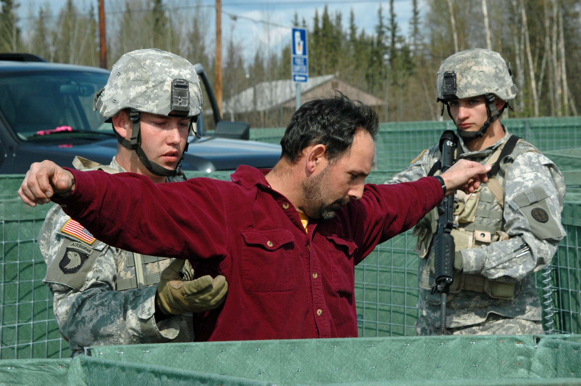 North Pole, Alaska – Sergeant Adam Dack with  the Nebraska National Guard searches a suspected terrorist that was removed from his vehicle during Entry Control Point (ECP) stop while his teammate provides security as part of an exercise conducted during Alaska Shield / Northern Edge 07.  Exercise Alaska Shield / Northern Edge 07 is a state of Alaska / US Northern Command sponsored homeland defense and defense support of civil authorities exercise; part of the national-level Ardent Sentry / Northern Edge 07 exercise.  Photo by Chief Mass Communications Specialist Greg Bingaman.