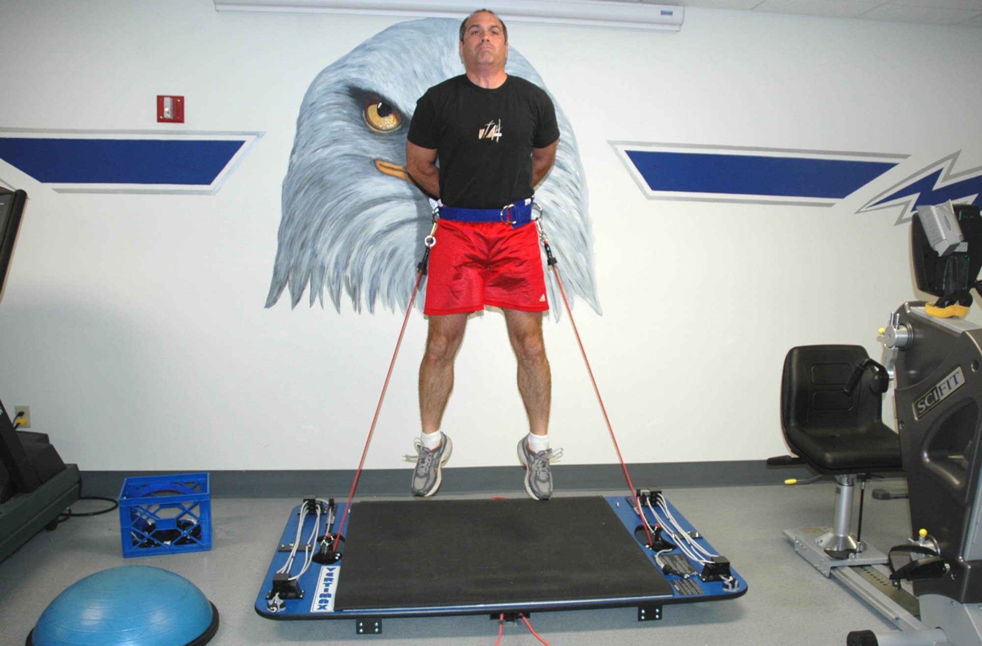 Michael Colombo, an athletic trainer for the 355th Medical Operations Squadron, jumps with 24 pounds of resistance on the Vertimax, the only jump-training equipment system in the Air Force. The Vertimax, which can provide up to 96 pounds of resistance, was introduced during the April 26 grand opening of D-M’s new Physical Therapy Clinic. (U.S. Air Force photo/Airman Jamie Coggan)