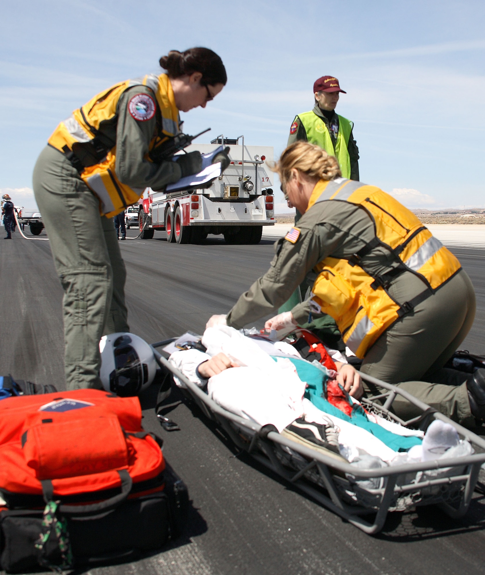 Medics attend to an "astronaut" during the shuttle landing exercise here May 5. As a secondary landing site, Edwards is required to conduct two exercises a year to make sure the base's capabilities to support shuttle landings still meet NASA's standards. (Photo by Jet Fabara)