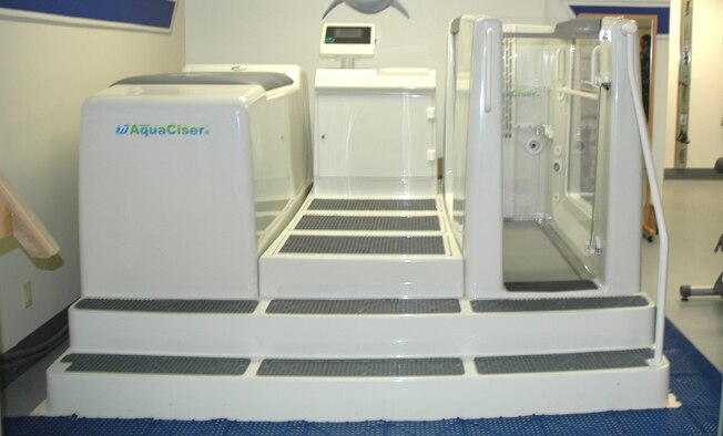 The Aquatic Rehab Treadmill, on display at the Physical Therapy Clinic’s grand opening at D-M April 26, lessens the impact on joints and affords runners quicker recovery progress after an injury. One of many new pieces of equipment at the new PTC, the treadmill will be available for use in June. (U.S. Air Force photo/Airman Jamie Coggan)