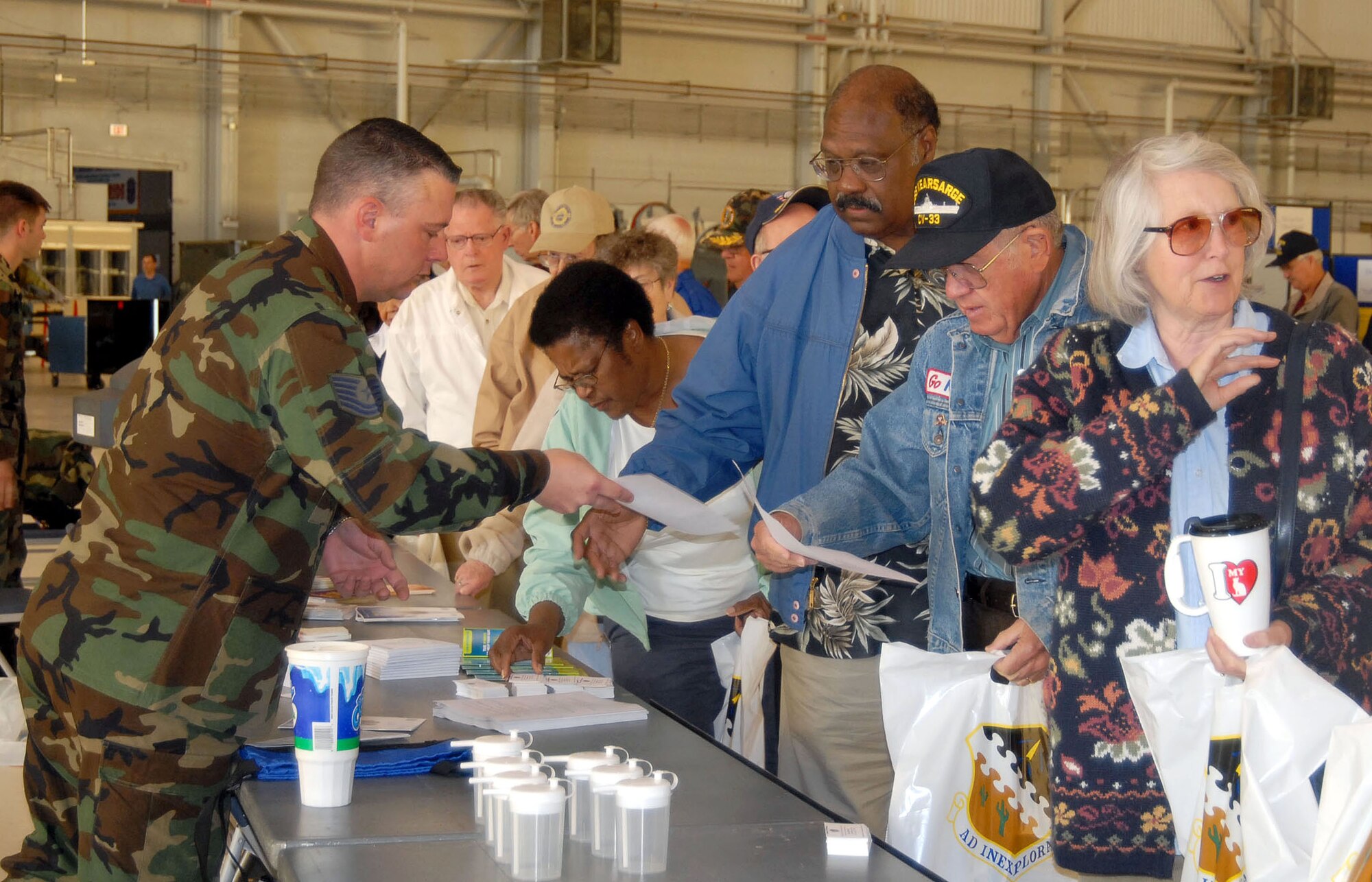 Tech. Sgt. Lance Holbrook, 95th Medical Group pharmacy noncommissioned officer in charge, provides information to retirees during Retiree Appreciation Day on May 5. (Photo by Airman 1st Class Julius Delos Reyes)