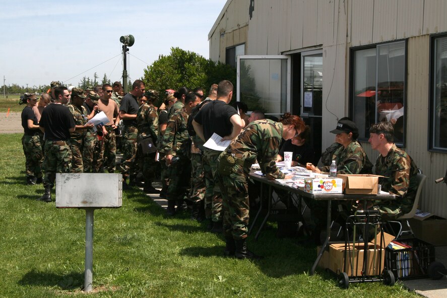 Hot Friday afternoon. Members of the 349th Medical Squadron stand in an out-processing line, during “Operation Golden Flower”, a mass casualty field training exercise, held on Travis AFB. (U.S. Air Force photo by Master Sgt. Wendy Weidenhamer) 