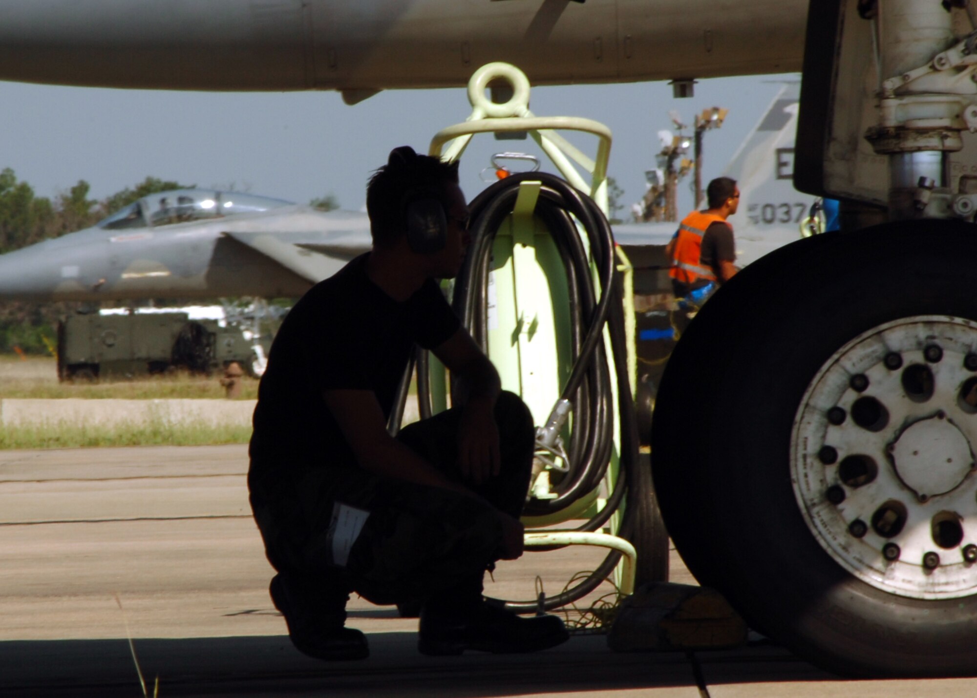 Staff Sgt. Andrew Parker, 33d Aircraft Maintenance Squadron crew chief, supervises the refueling operation of an F-15C at Eglin Air Force Base, Fla. The 33d Fighter Wing is conducting surge operations May 8-10, averaging more than 80 sorties a day. Surge operations test maintainers' abilities to generate more sorties than normal and give pilots an increased number of flying hours in a condensed time period.