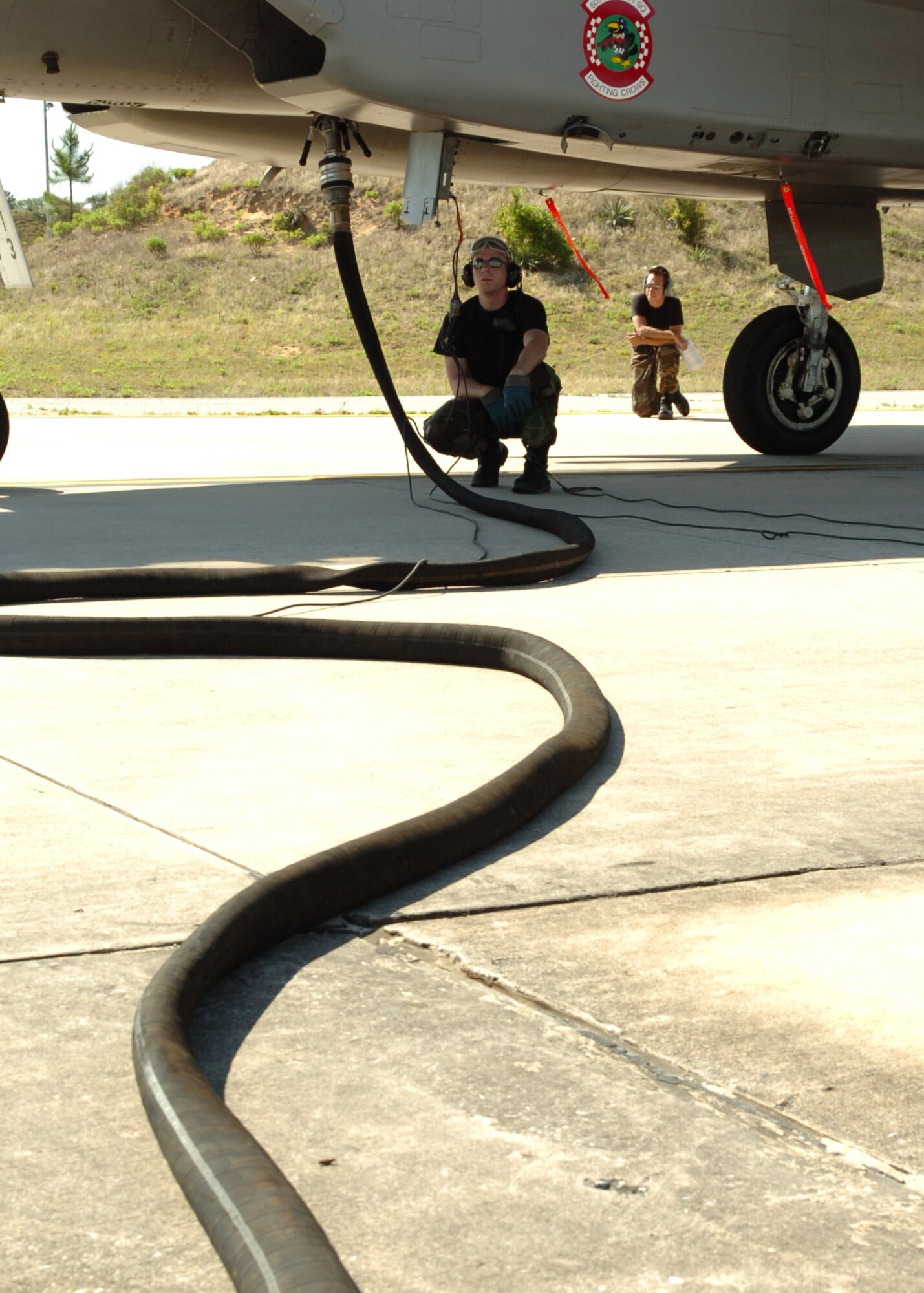 Airmen from the 33d Aircraft Maintenance Squadron, wait to begin the refueling operation of an F-15C at Eglin Air Force Base, Fla. The 33d Fighter Wing is conducting surge operations May 8-10, averaging more than 80 sorties a day. Surge operations test maintainers' abilities to generate more sorties than normal and give pilots an increased number of flying hours in a condensed time period.