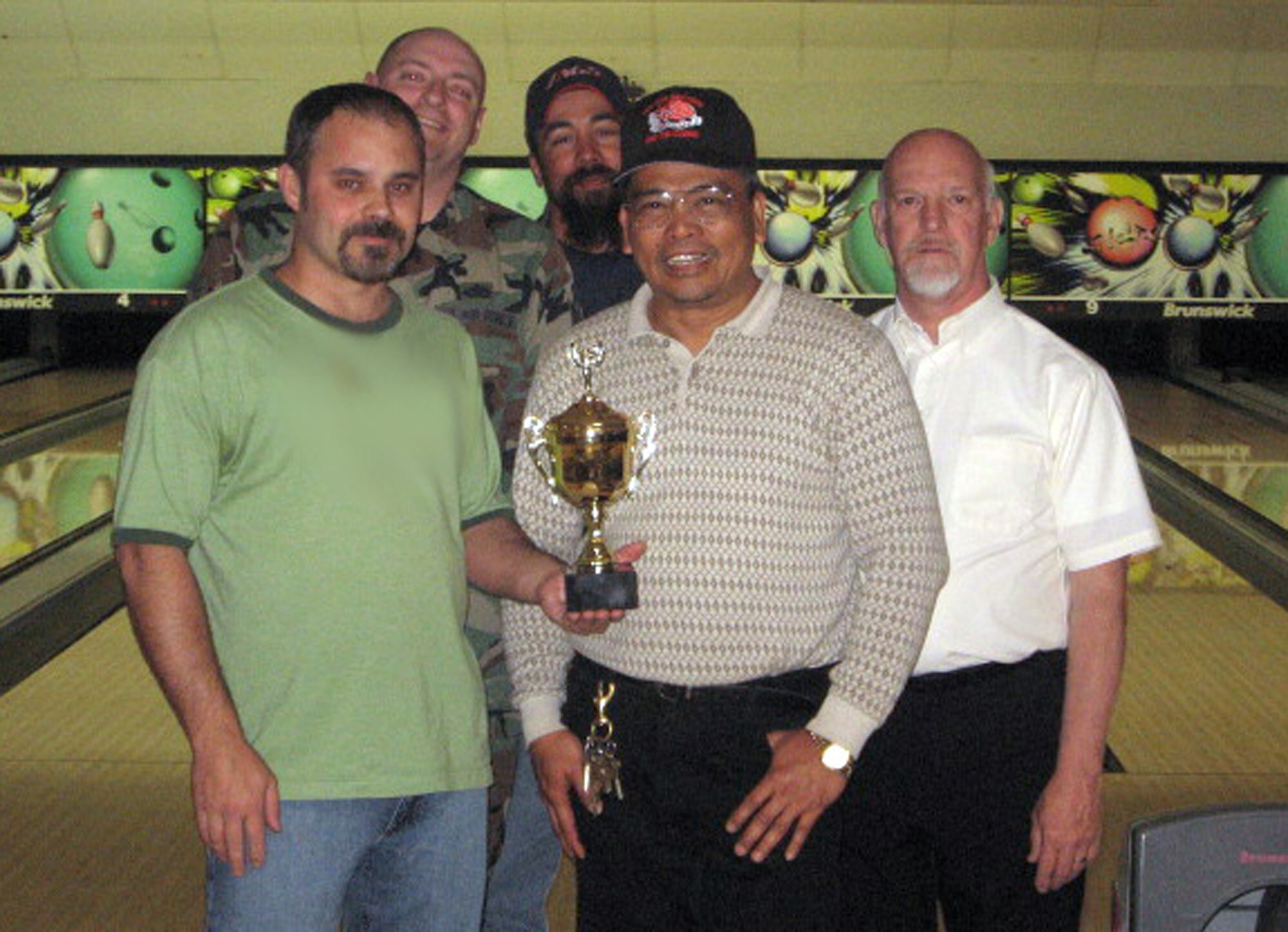 FAIRCHILD AIR FORCE BASE, Wash. – Clockwise from left front: Richie Teller, Tech. Sgt. Chris Prater, Gerry Aguiar, Merl Briggs and Vic Passion pose with their second place trophy from the Fairchild intramural bowling league. The 92nd Civil Engineer Squadron team also included Staff Sgt. John Massad, Steve Csiti, Chito Nacion, Billy Vernor and Dana Whittaker. (U.S. Air Force photo illustration/Jason McCathren)