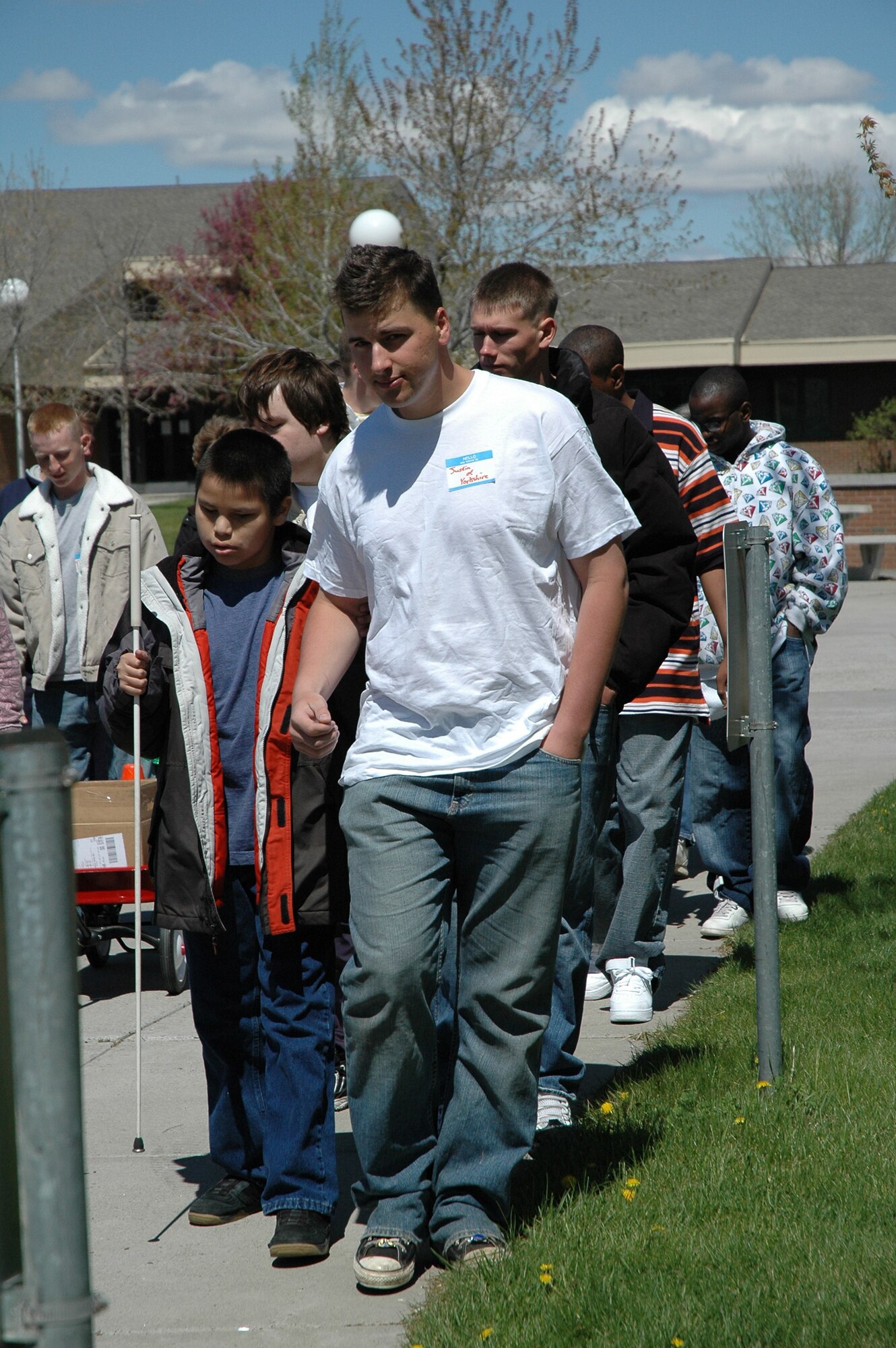 Security Forces volunteers help visiually impaired athletes navigate their way to the track and field area at East Middle School. (U.S. Air Force photo / Valerie Mullett)
