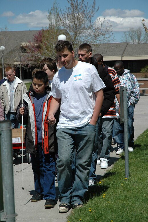 Security Forces volunteers help visiually impaired athletes navigate their way to the track and field area at East Middle School. (U.S. Air Force photo / Valerie Mullett)