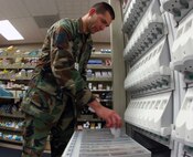 MINOT AIR FORCE BASE, N.D. – Tech. Sgt. Mark Werner, 5th Medical Group pharmacy technician, replenishes medication from an automatic dispenser at the base pharmacy here. The 5th MDG is one of four groups in the 5th Bomb Wing. The wing was recently selected as winner of the Air Force Verne Orr Award for 2006. This award is presented annually by the Air Force Association and recognizes an Air Force unit for best use of human resources. (U.S. Air Force photo by Airman 1st Class Joe Rivera)